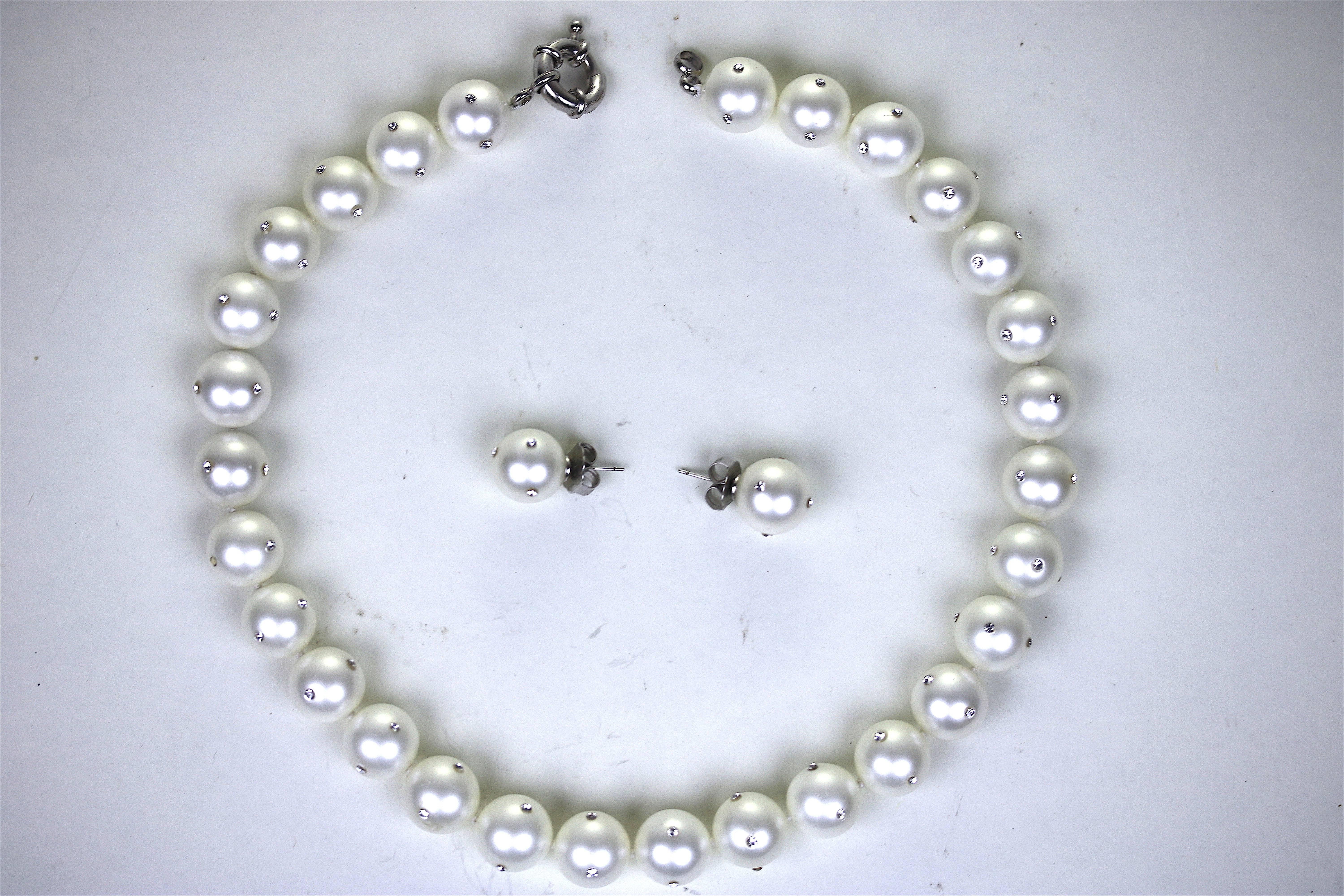 A Gorgeous unique 14-16 mm faux pearl (29 pearls on necklace) with inlay all-around of sparkly cz diamond inlay, spaced around each pearl both the necklace, with silver spring ring clasp and matching pair of pierced pearl earrings with silver post.