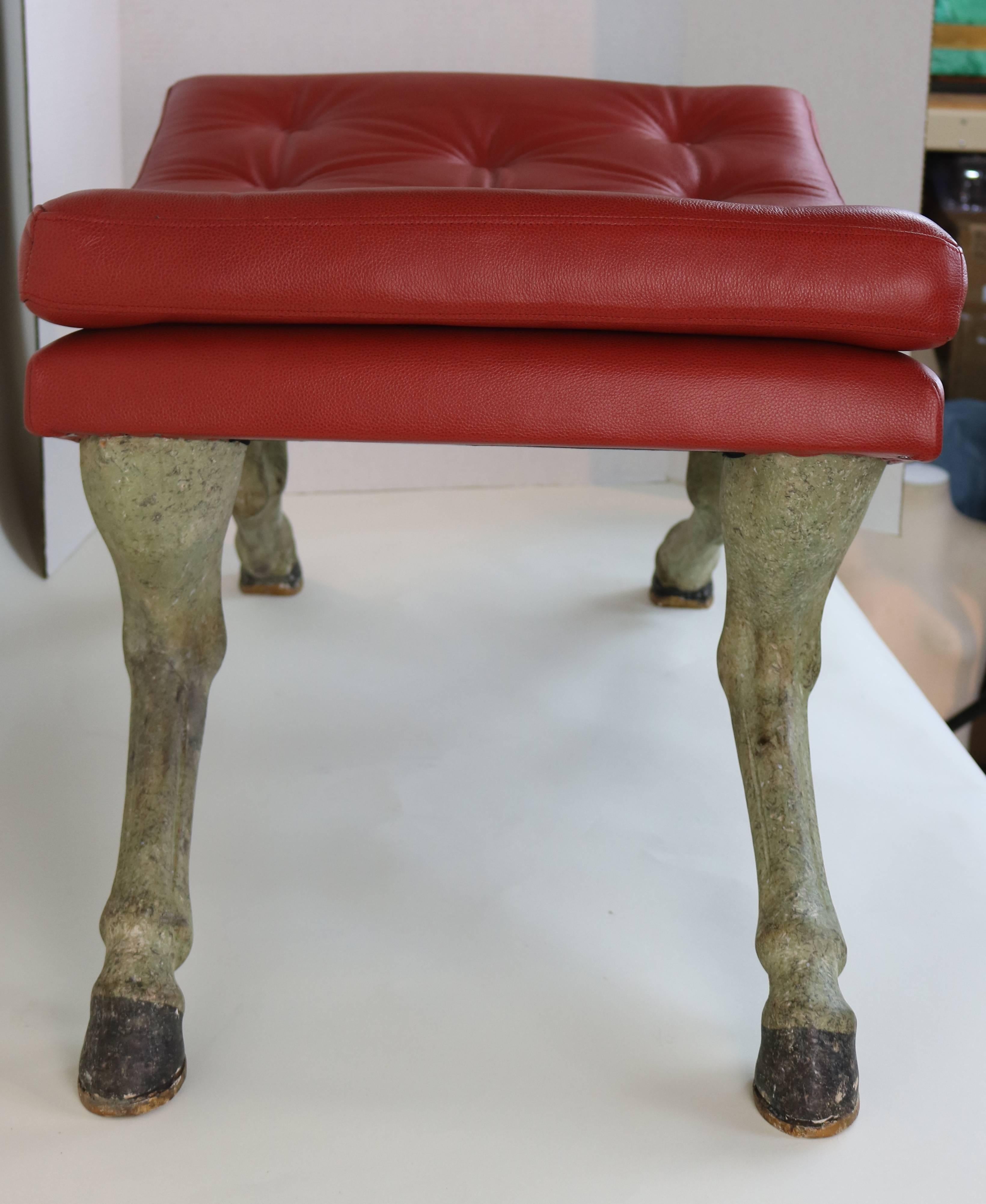 Art and style merge in a sophisticated fashion forward antiqued painted hoof leg base with persimmon button tufted leather upholstered seat ottoman.
Looks perfectly at home in interiors of any theme or era,
its unique styling draws comment and