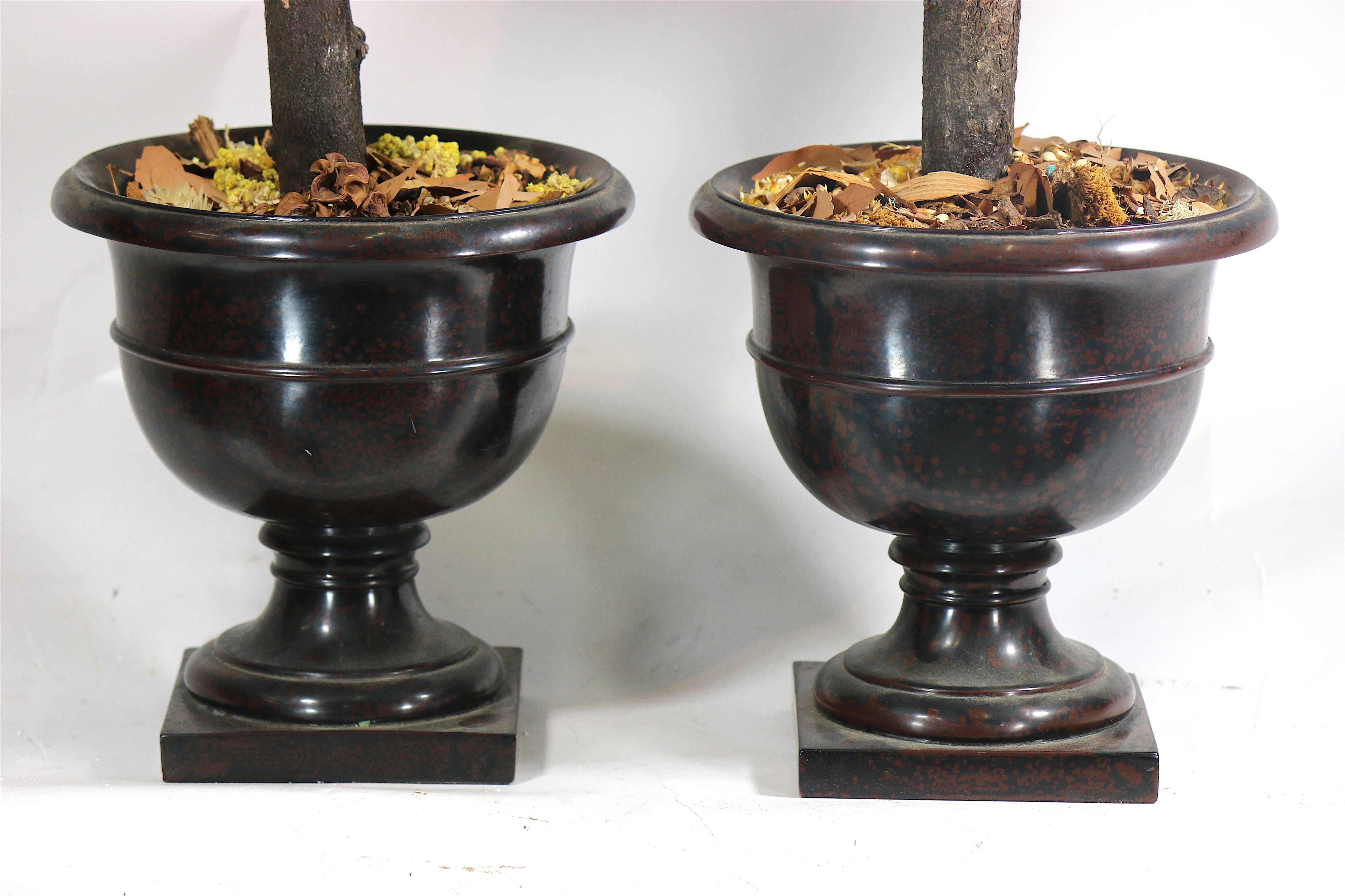 Decoratively alluring pair of topiaries in Mid-Century well turned resin urns.
Embellishment such as flowers can be added to the moss or a new topper can be added-see in situ photo on dining table.
Measures: 9  1/2