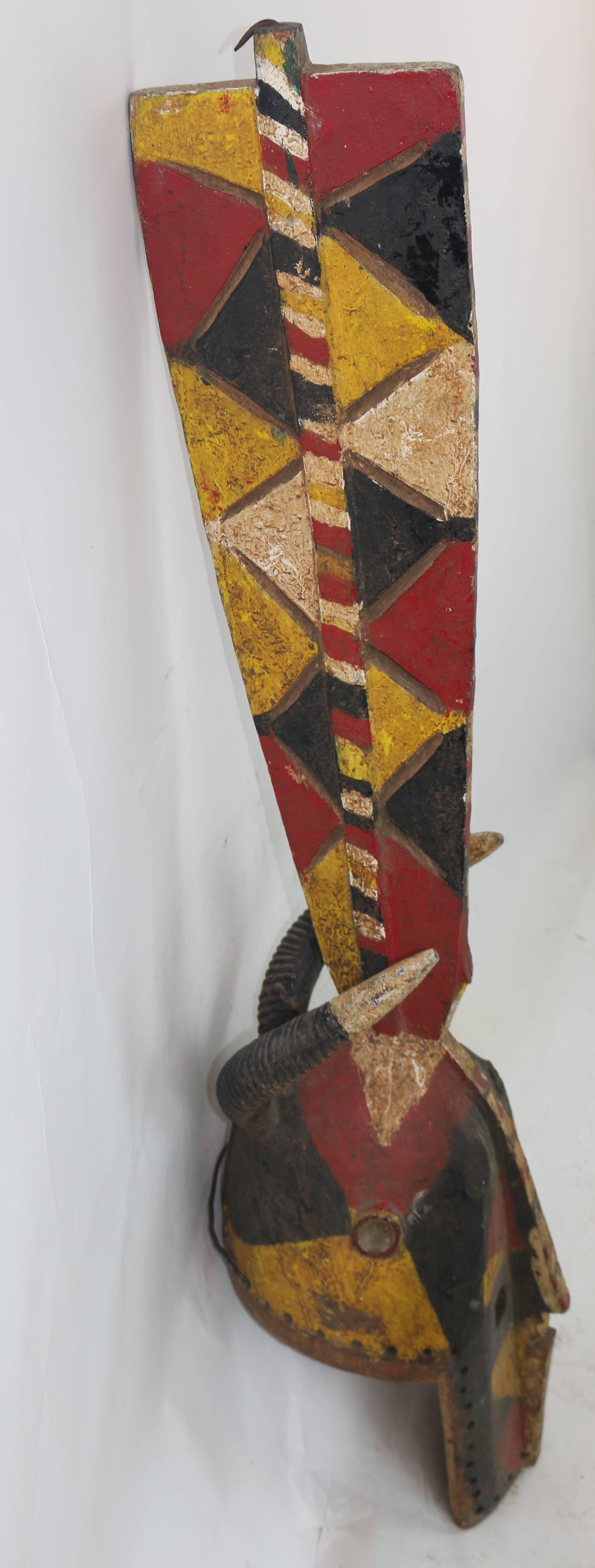 Tribal Powerful Tall Wood African Carved Pigmented Mask  For Sale