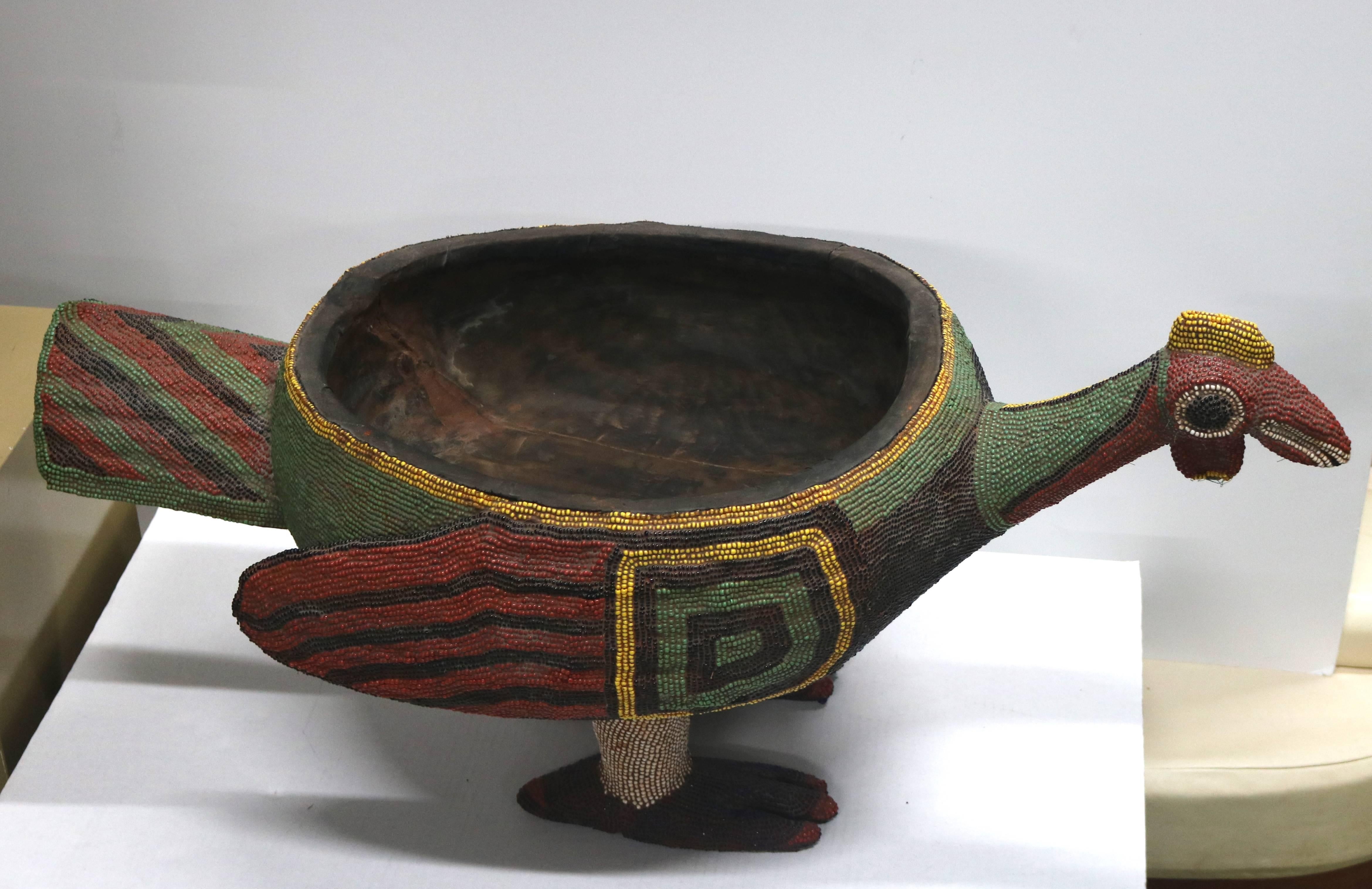 Mid-Century huge beaded wood bird bowl, a wood form bowl in the shape of a bird with colorful beaded design throughout the surface, most likely from Cameroon-Africa. A unique rarity!!
Colorful and fantastical would make a great centerpiece or center