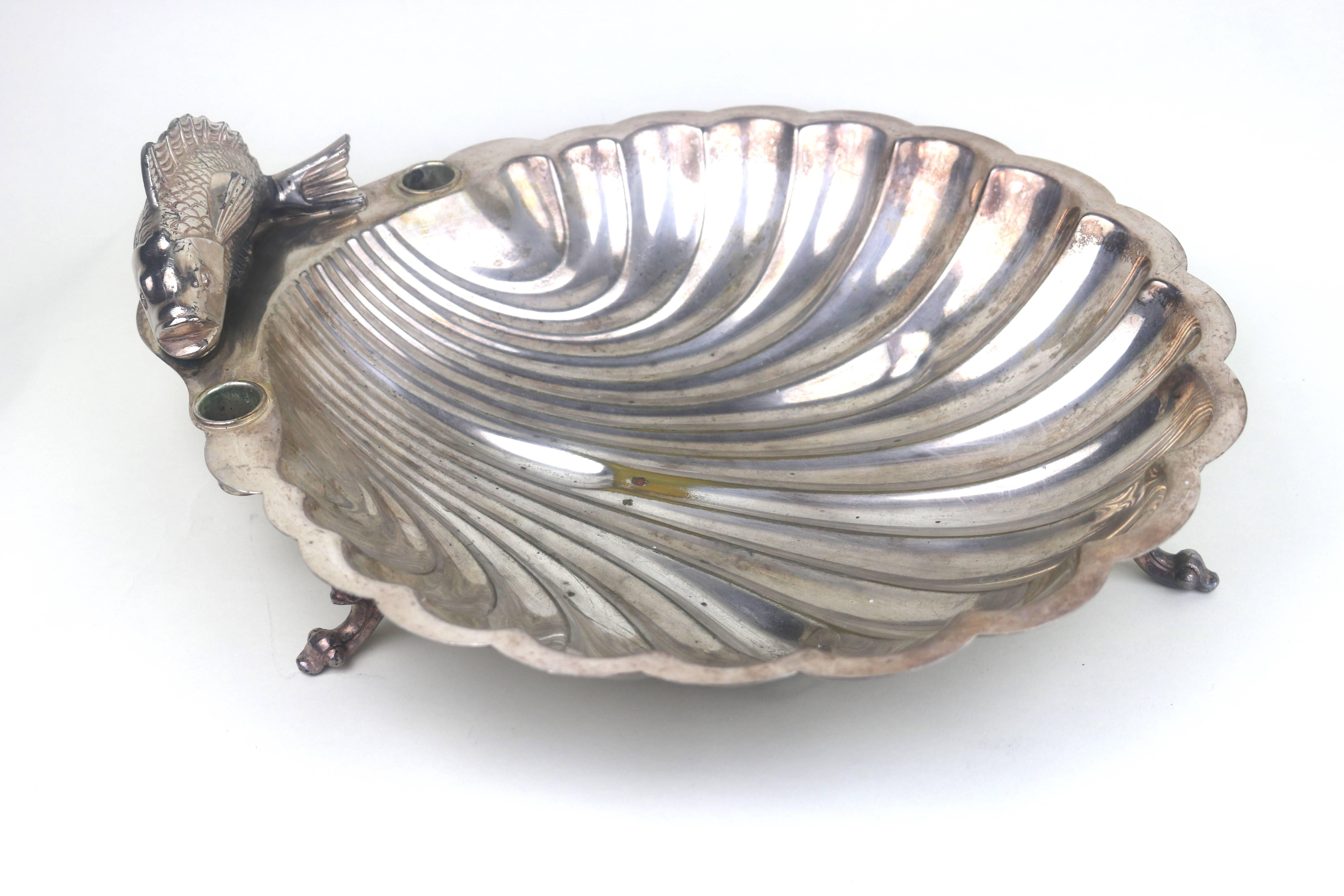 Beautiful Silver Plate on Copper Large Articulated Engraved Designed Fish Mounted scallop edged grooved pattern bowl with cups on each side for candles on three nicely detailed legs. a few areas of copper exposed.
A Beautiful and Memorable Serving