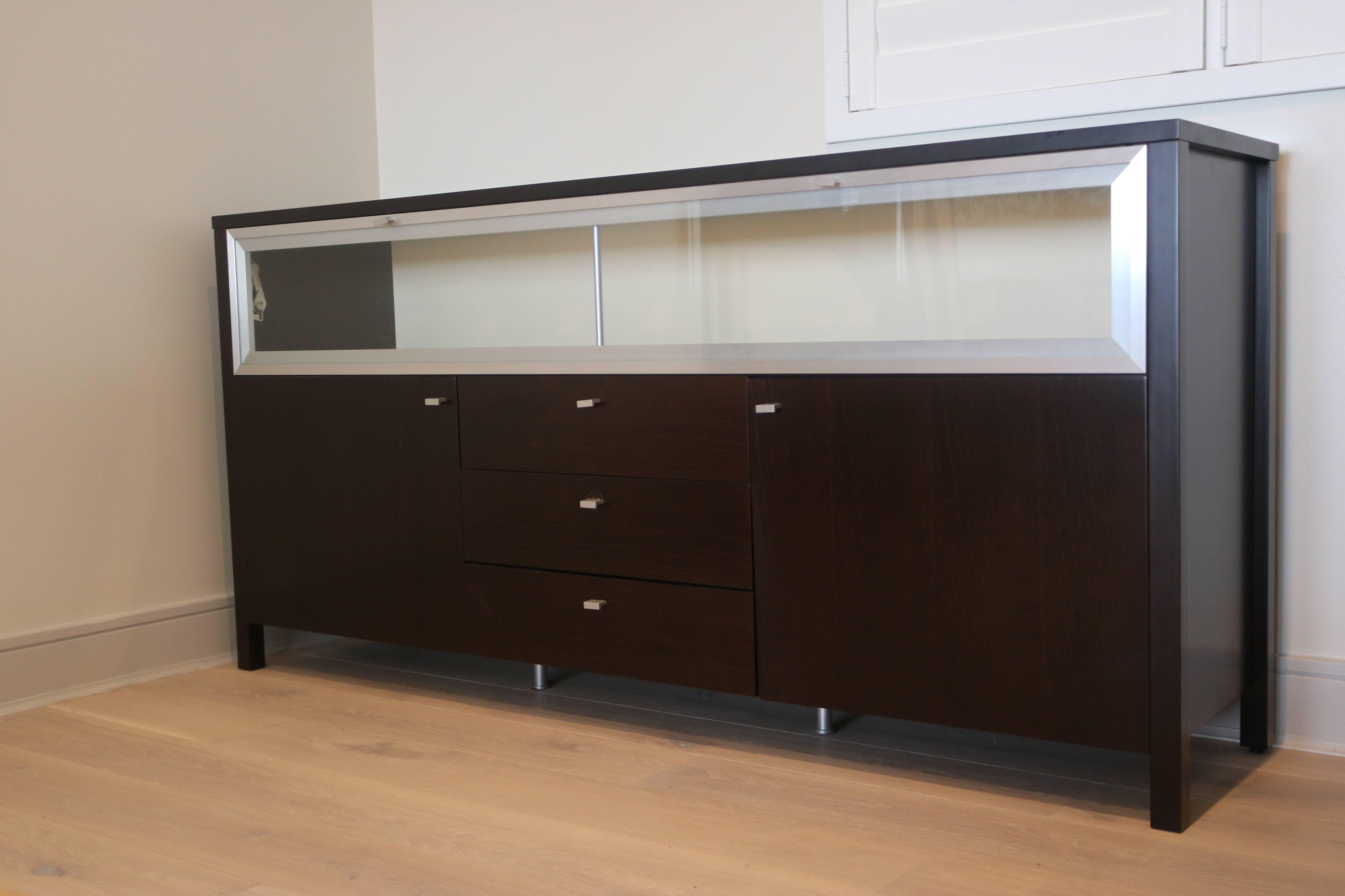 IT'S AN AMAZING VALUE FOR THIS STYLISH CABINET.
20th Century 1980s Sleek Modern Art Deco Style Glass Wood  Cabinet buffet credenza  sideboard Bar or Dresser in ebonized black full finished Stained wood with chrome metal trim and hardware.
Top is