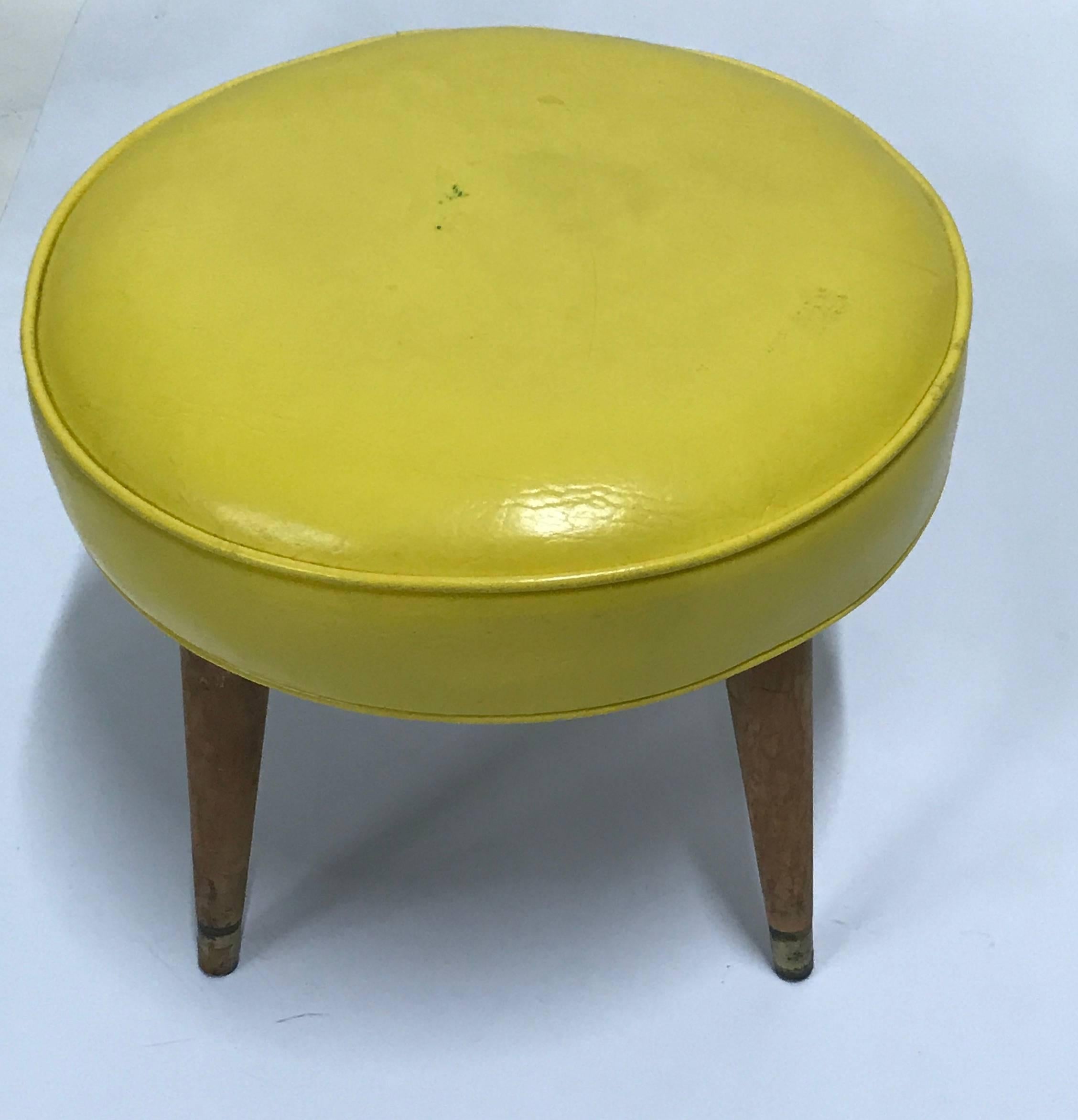 Cool Mid-Century Modern stool, Ottoman, tapered splayed light maple wood legs with brass ferules, cool shiny coated yellow vinyl upholstery with double welting, attributed to Paul McCobb.