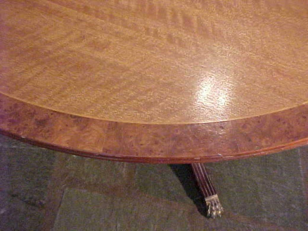 The ultimate Refined George III English dining breakfast table in a marvelous rare combination of lustrous satinwood crossbanding with burl border double reeded edge 48