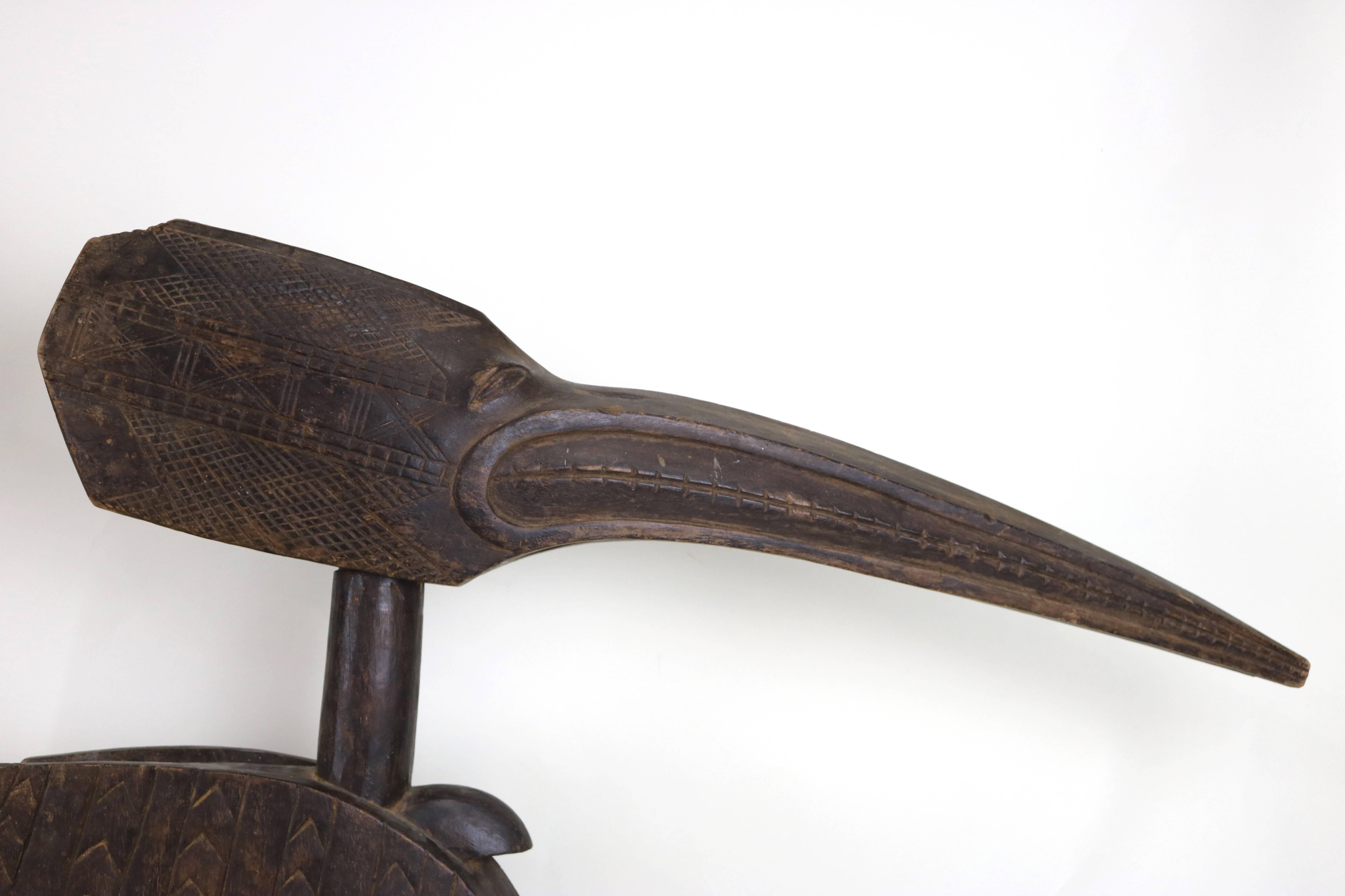 Impressive scale pair of  32 “ high. exotic large African wood baga bird ethnographic carved sculptures. Detailed wood carved designs on the head sitting on the intricately hand carved body, wonderful aged wood patina.
A Spectacular statement piece