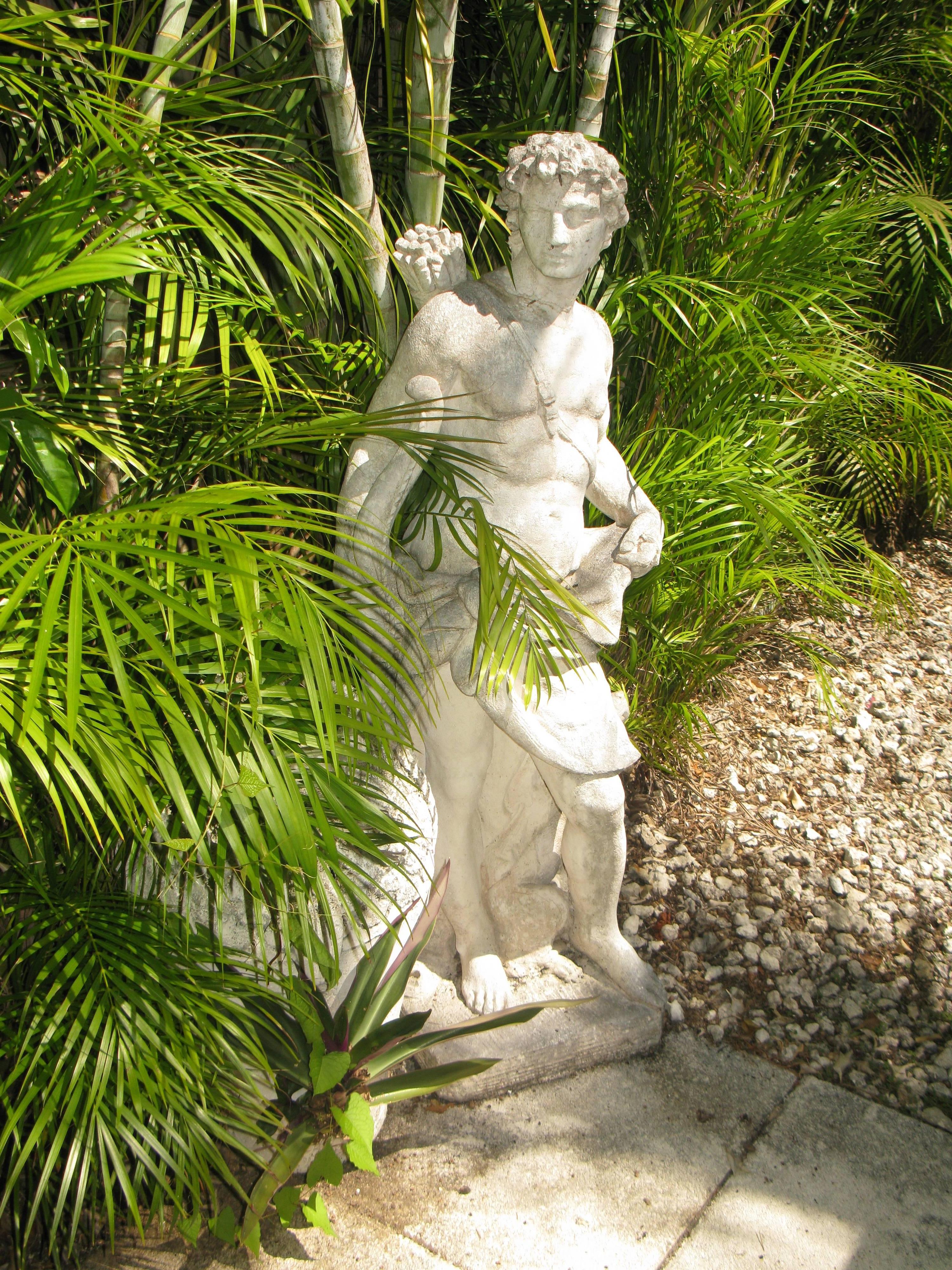  Nice Cast stone white weathered finish garden statue of Apollo the hunter in the neoclassic style carrying his arrows strapped on his back with his trusty dog at his feet. In Greek and Roman mythology, Apollo is one of the most important and