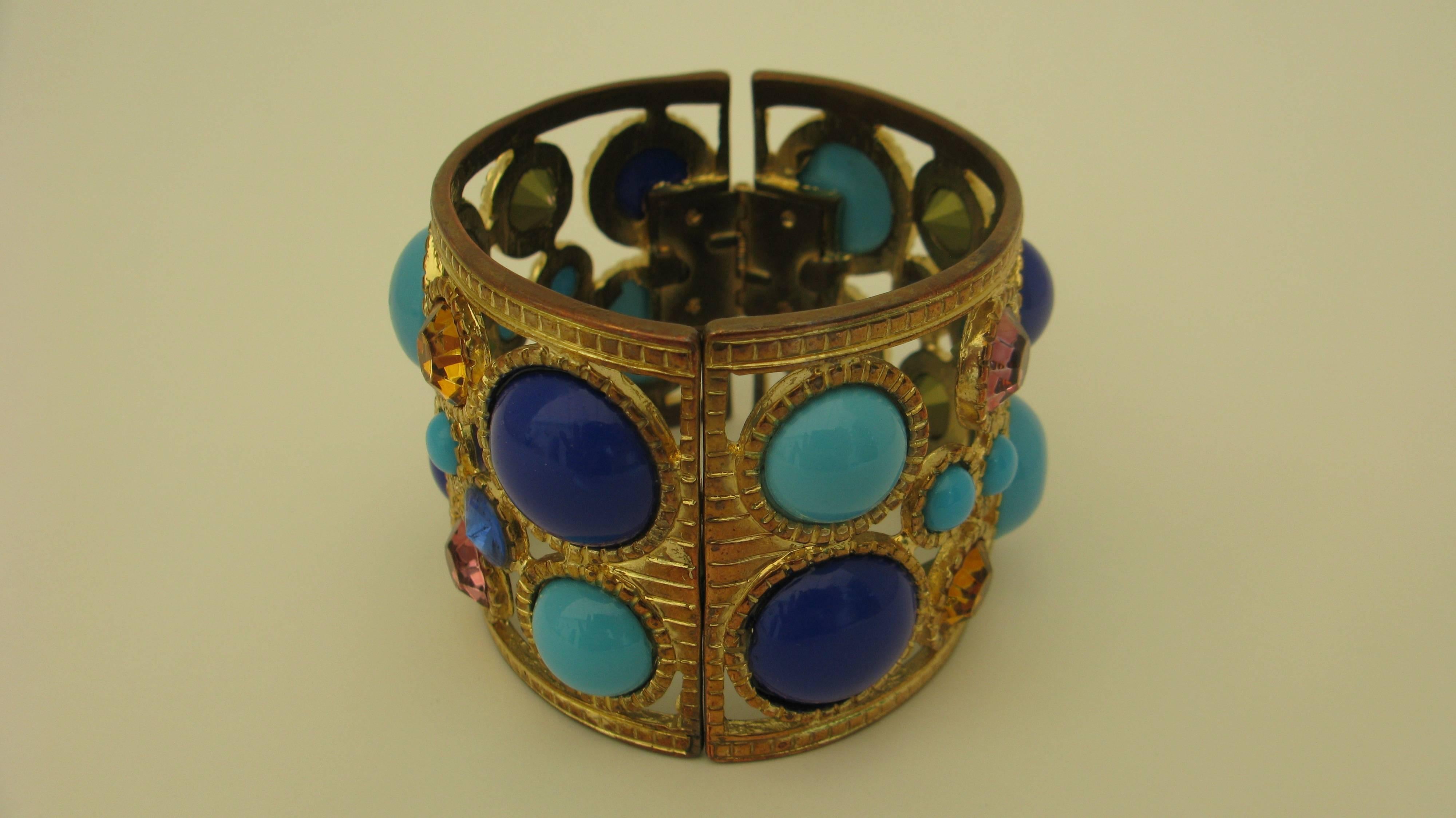 A beautiful KJL (marked) vintage bracelet--faux turquoise, cobalt, rose and gold crystals all around the surface in a gold plate bezel setting--hinged with magnetic closure.

From the Edith Hale Harkness Estate.