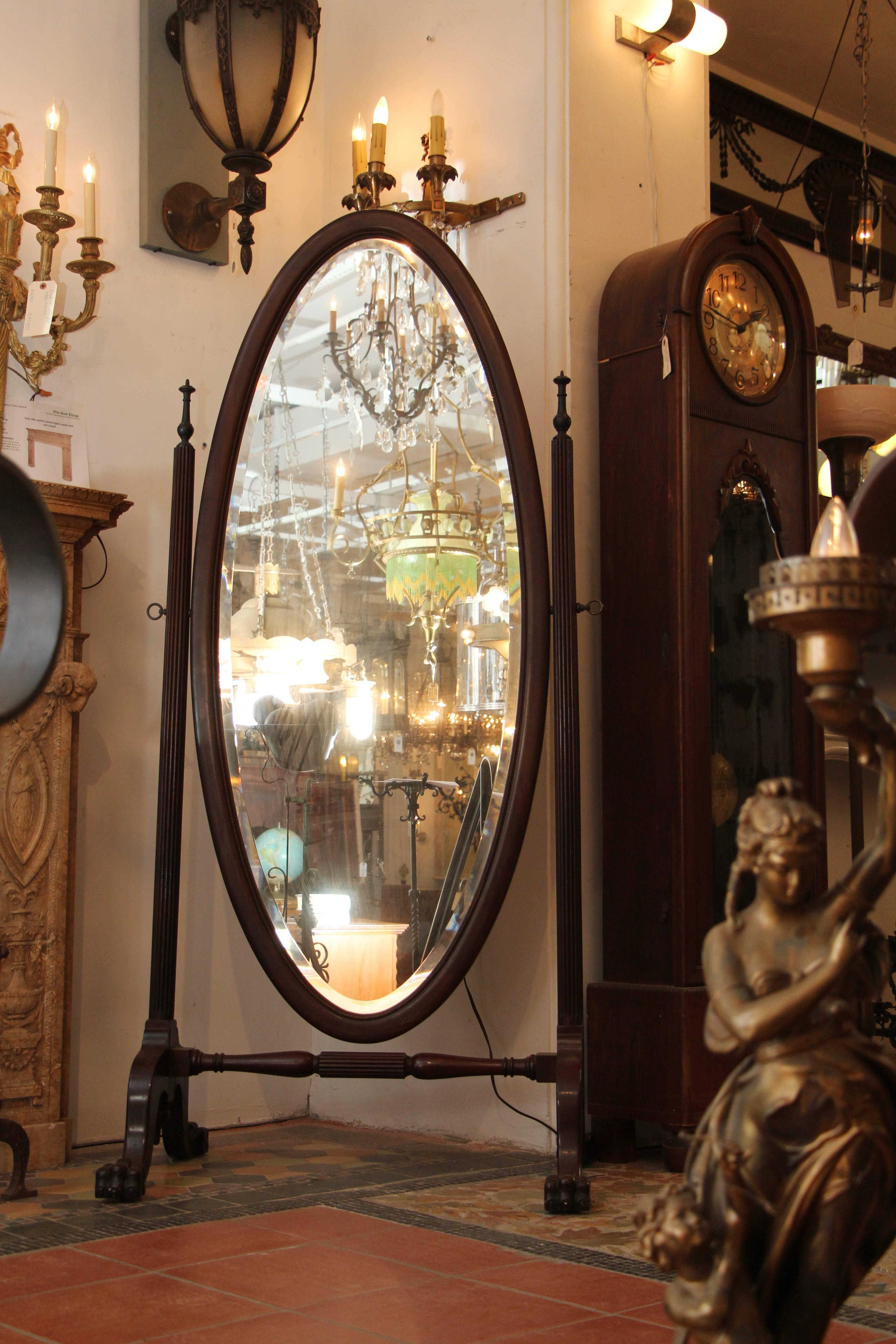 1910 freestanding mahogany cheval mirror with beveled glass and beaded detail. The Stand has claw feet and some carved features. This item can be viewed at our 5 East 16th St, Union Square location in Manhattan.