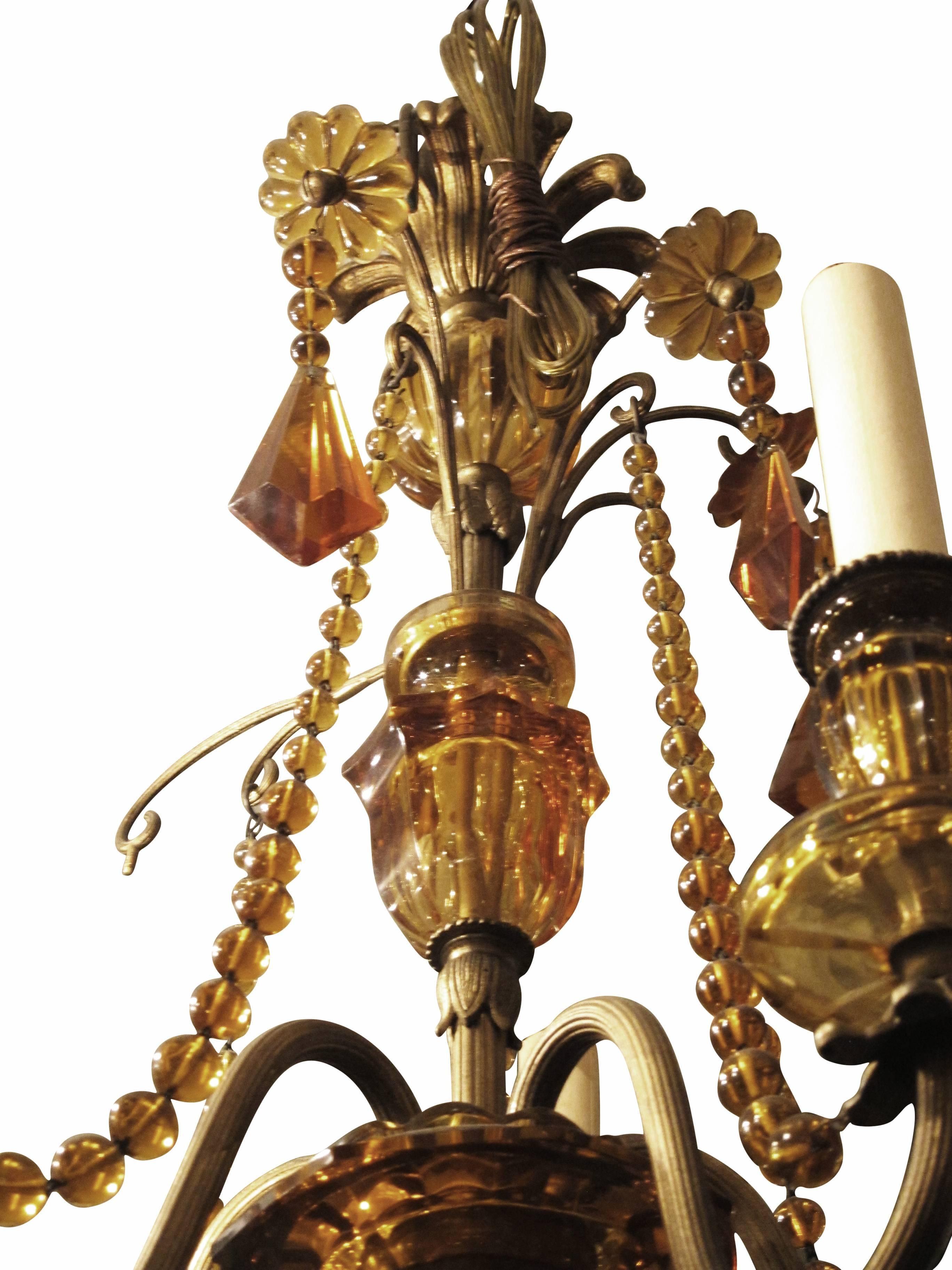 1920s French Venetian style chandelier with cut amber crystal and bronze details. Made in 1920. This can be seen at our 2420 Broadway location on the upper west side in Manhattan.