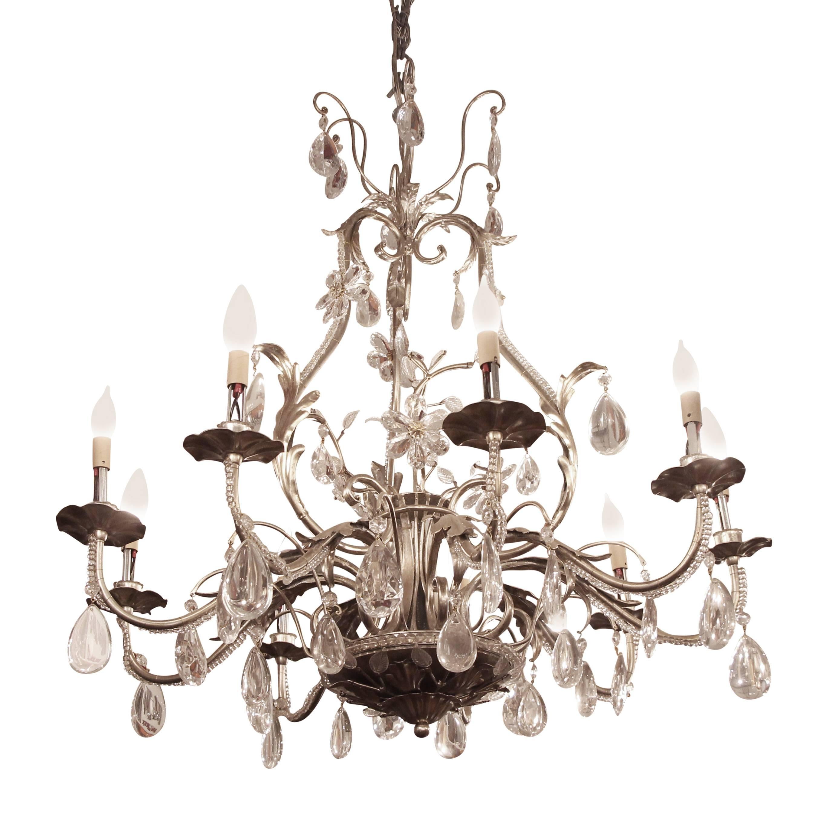 2005 Florentine style nine-arm steel chandelier with central branch motif, crystal leaves throughout and crystal drops. This can be seen at our 2420 Broadway location on the upper west side in Manhattan.