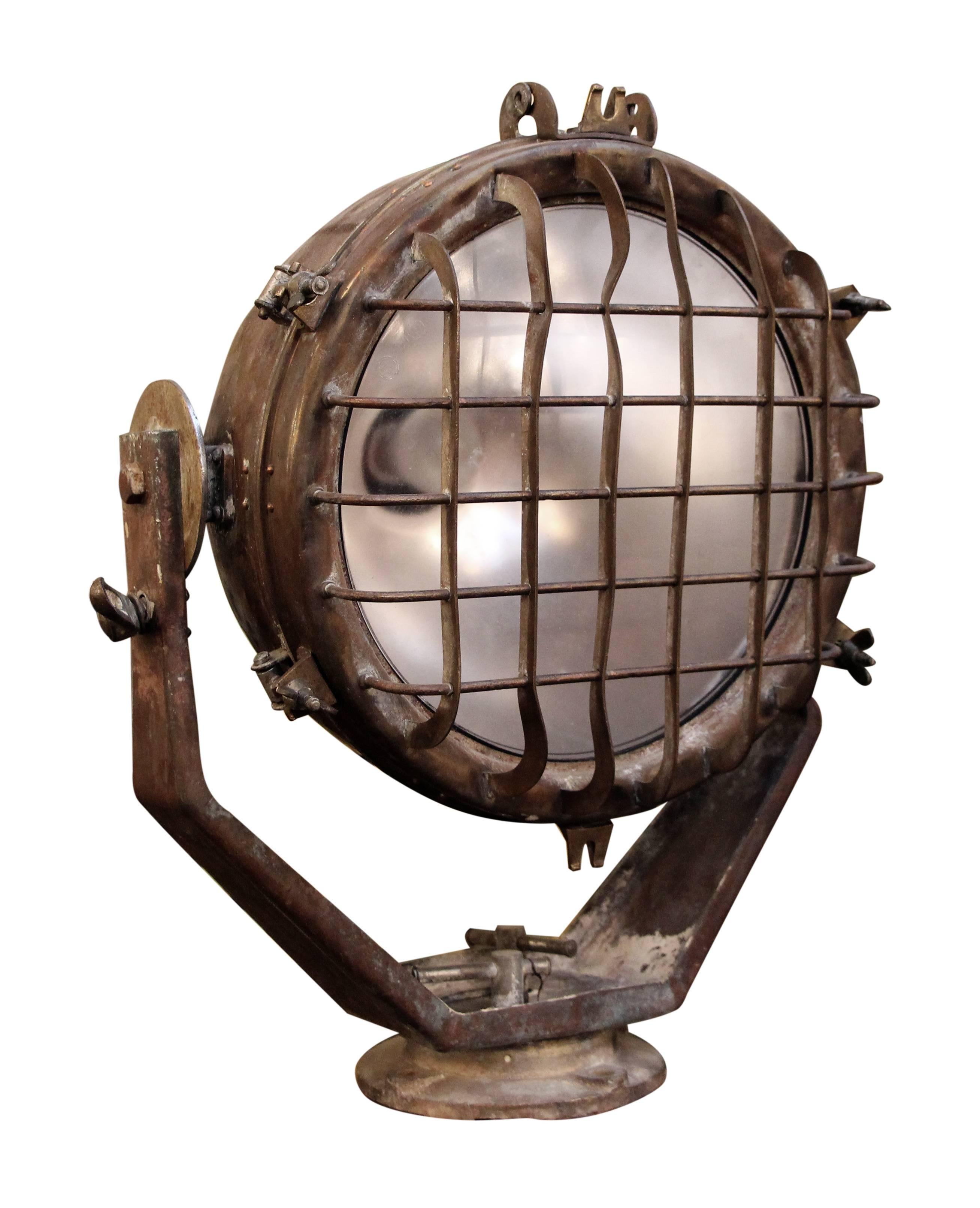 1930s adjustable large brass ship spotlight with wire cage. This can be seen at our 1800 South Grand Ave location in Downtown LA.