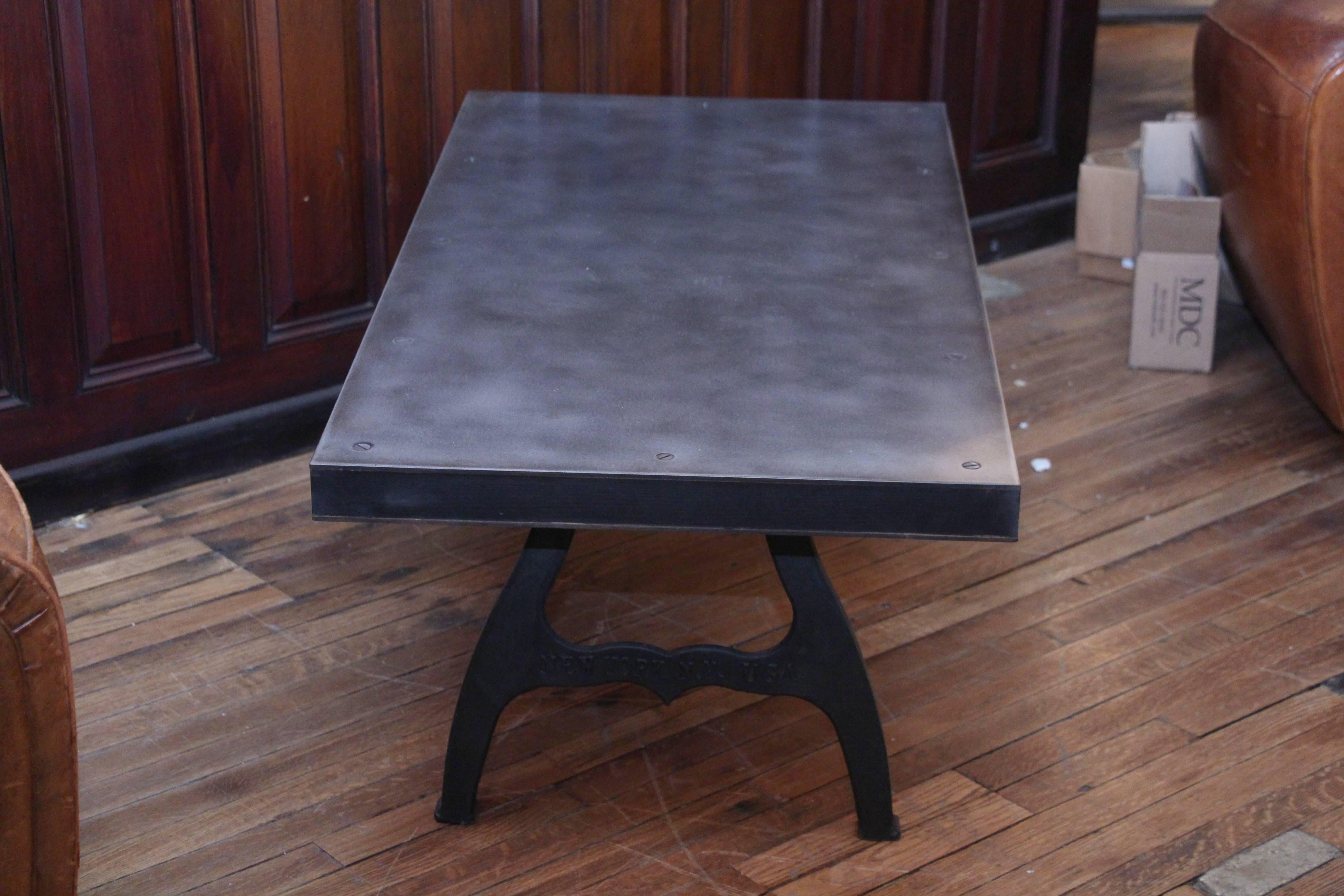 Mid-Century Modern style steel top coffee table with cast iron Industrial legs. Top consists of a 1/4 inch steel top and bottom with a salvaged floor joist core.

Please note each table is custom built and therefore each table varies slightly due to