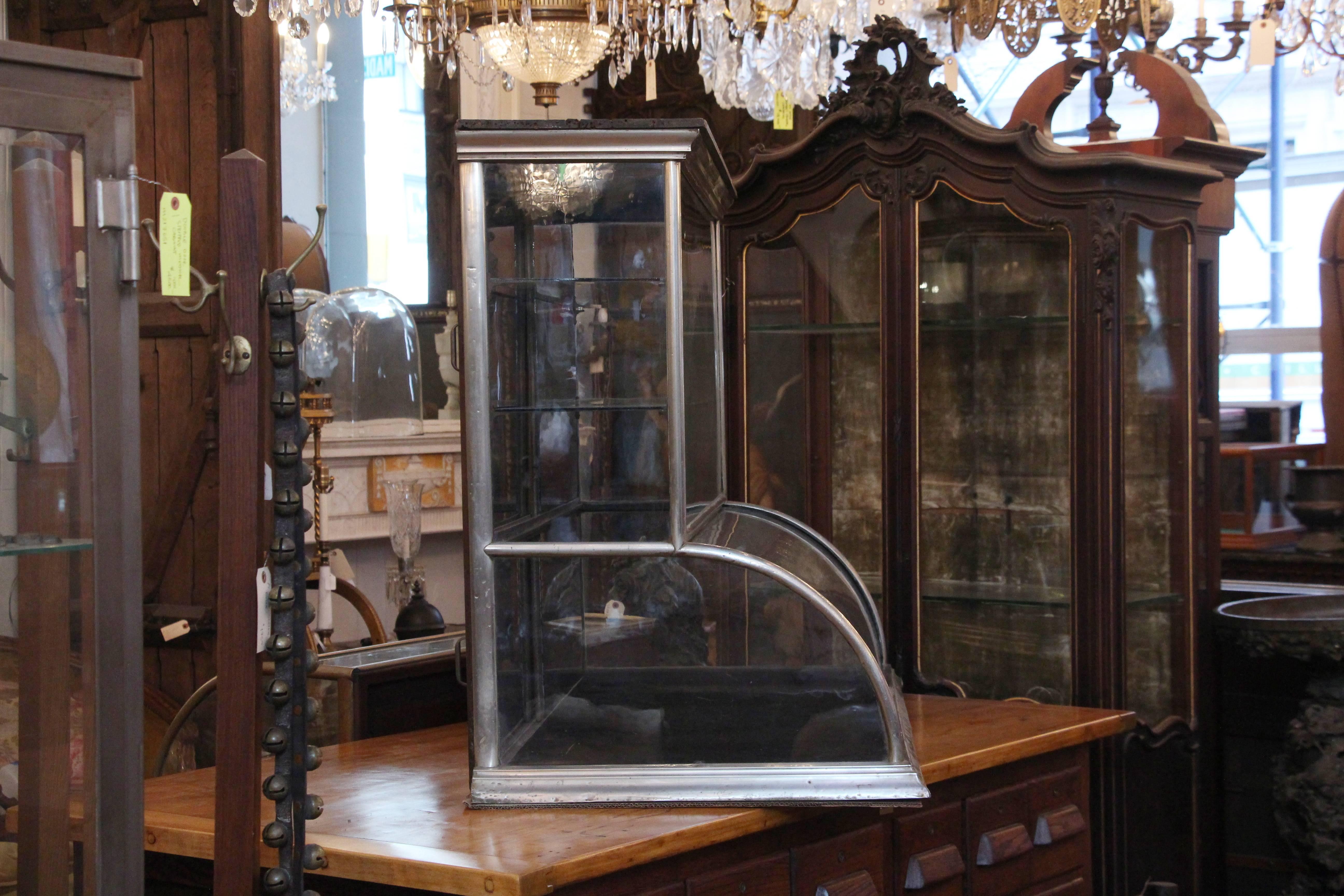 Late 19th Century 1890s Curved Front Tower Showcase with Nickel Trim and Hand Silvered Doors