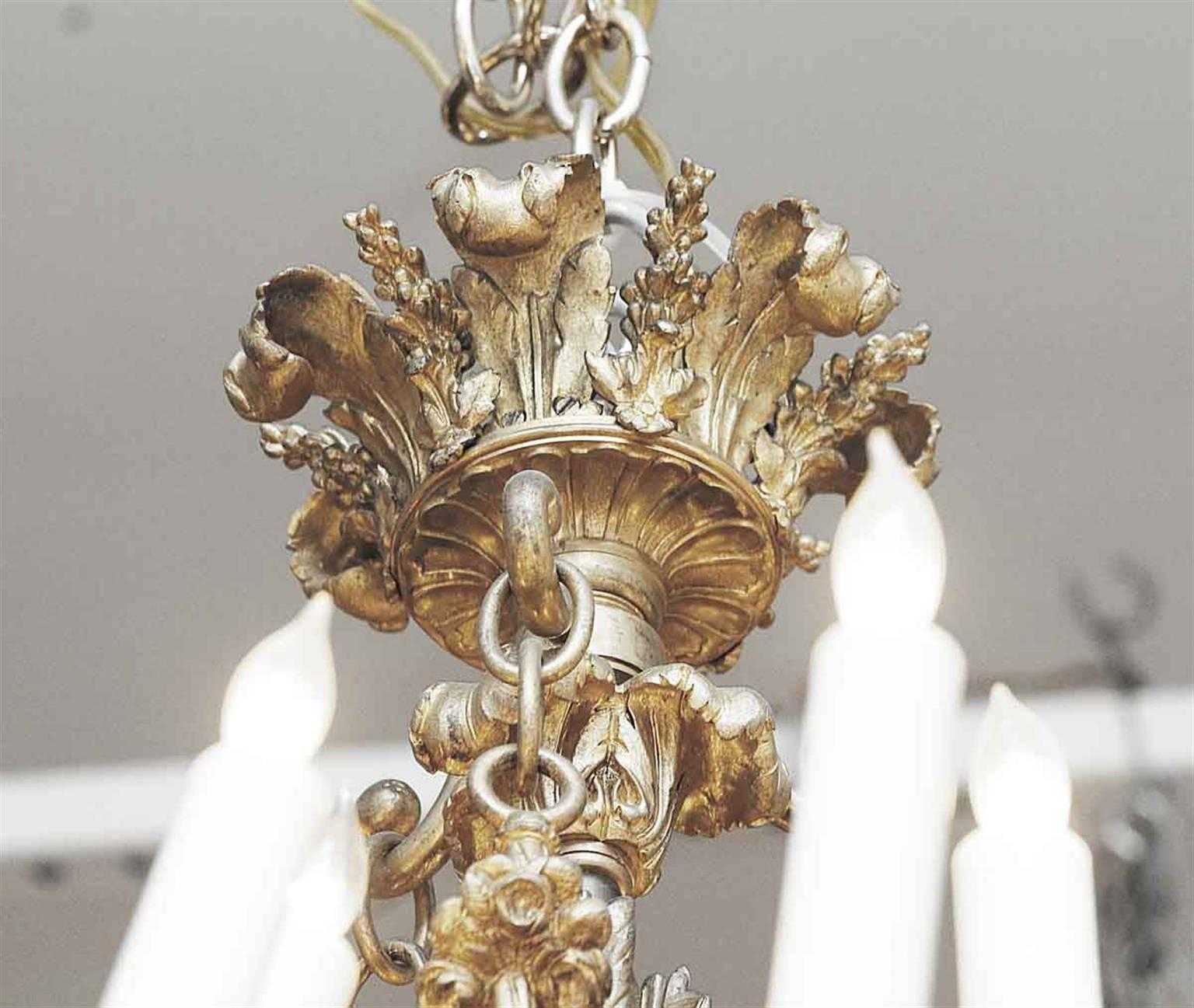 A grand Louis XV style chandelier in gilded bronze, with arrow and quiver forms, finely detailed cups, bobeches, and curling florets on the 16 arms. Please note all candles have a slight original lean inwards. Made in France, circa 1860. This can be