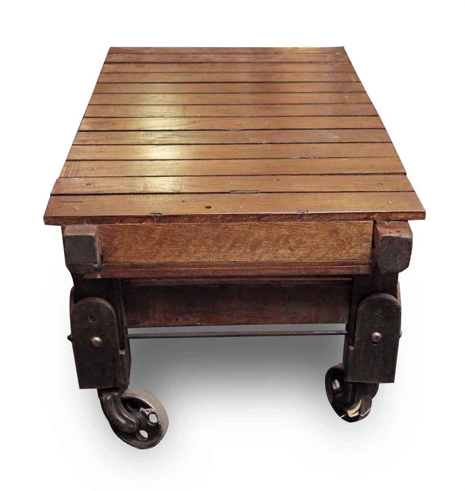 1920s extra tall foundry or factory cart table. Features wood slats and smooth rolling cast iron casters and iron supports. This can be seen at our 302 Bowery location in Manhattan. Restored.