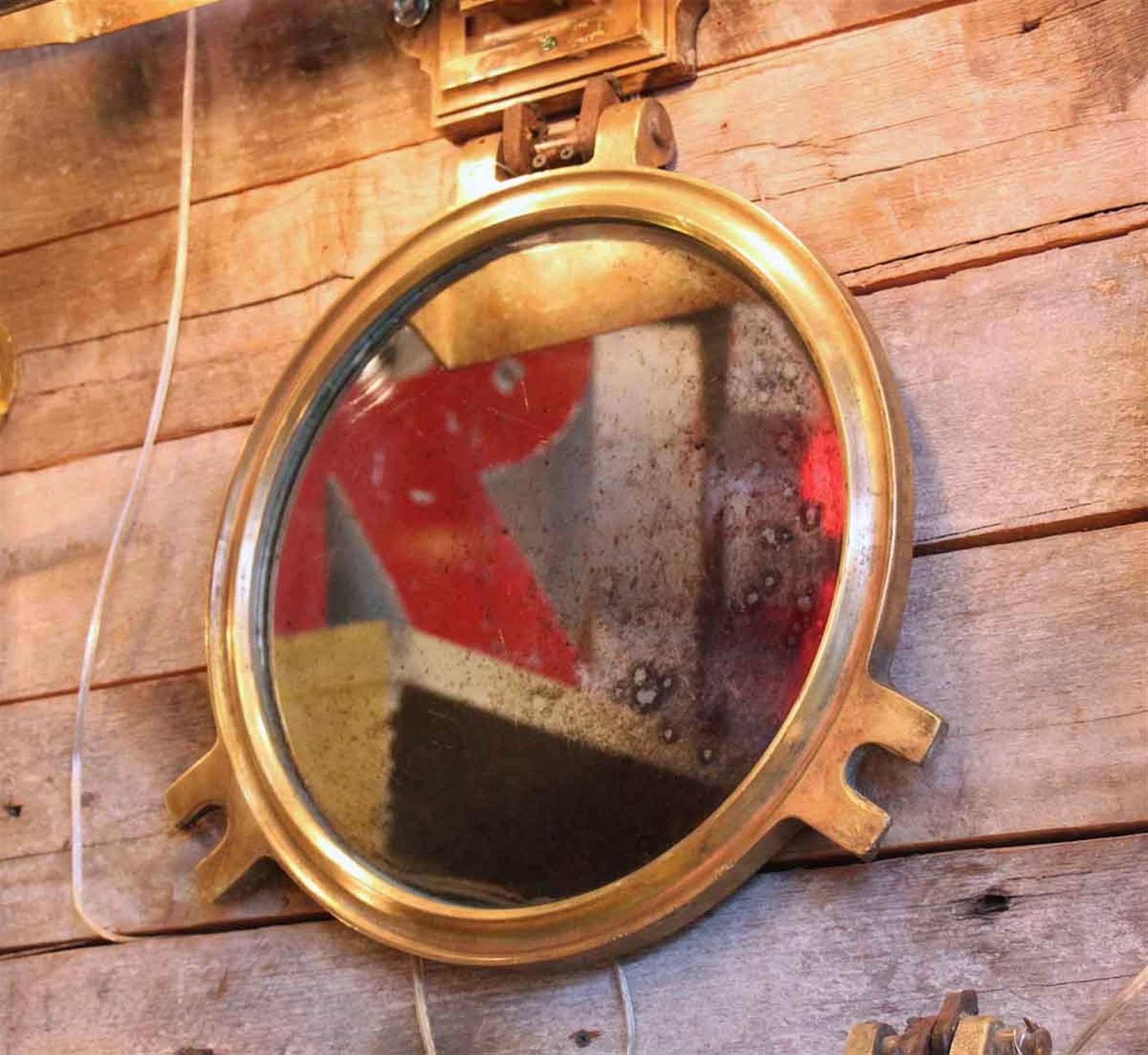 A very beautiful salvaged polished round bronze porthole from the, 1950s with a lightly distressed mirror installed. Several available at time of posting. This can be viewed at one of our New York City locations. Please inquire for the exact address.