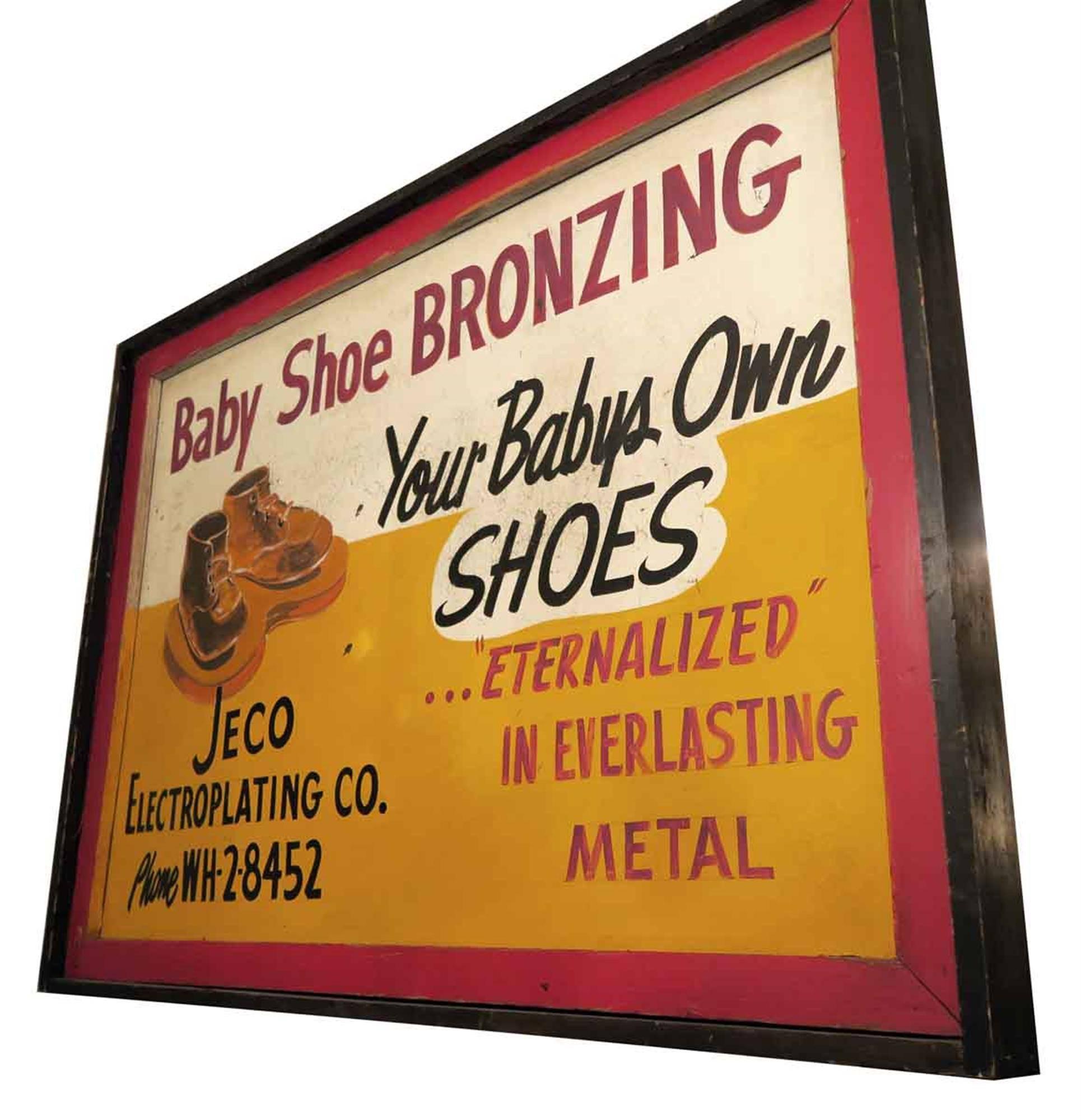 1940s wooden framed orange, red, white and black double sided Baby Shoe Bronzing sign. This can be seen at our 1800 South Grand Ave location in Downtown LA.