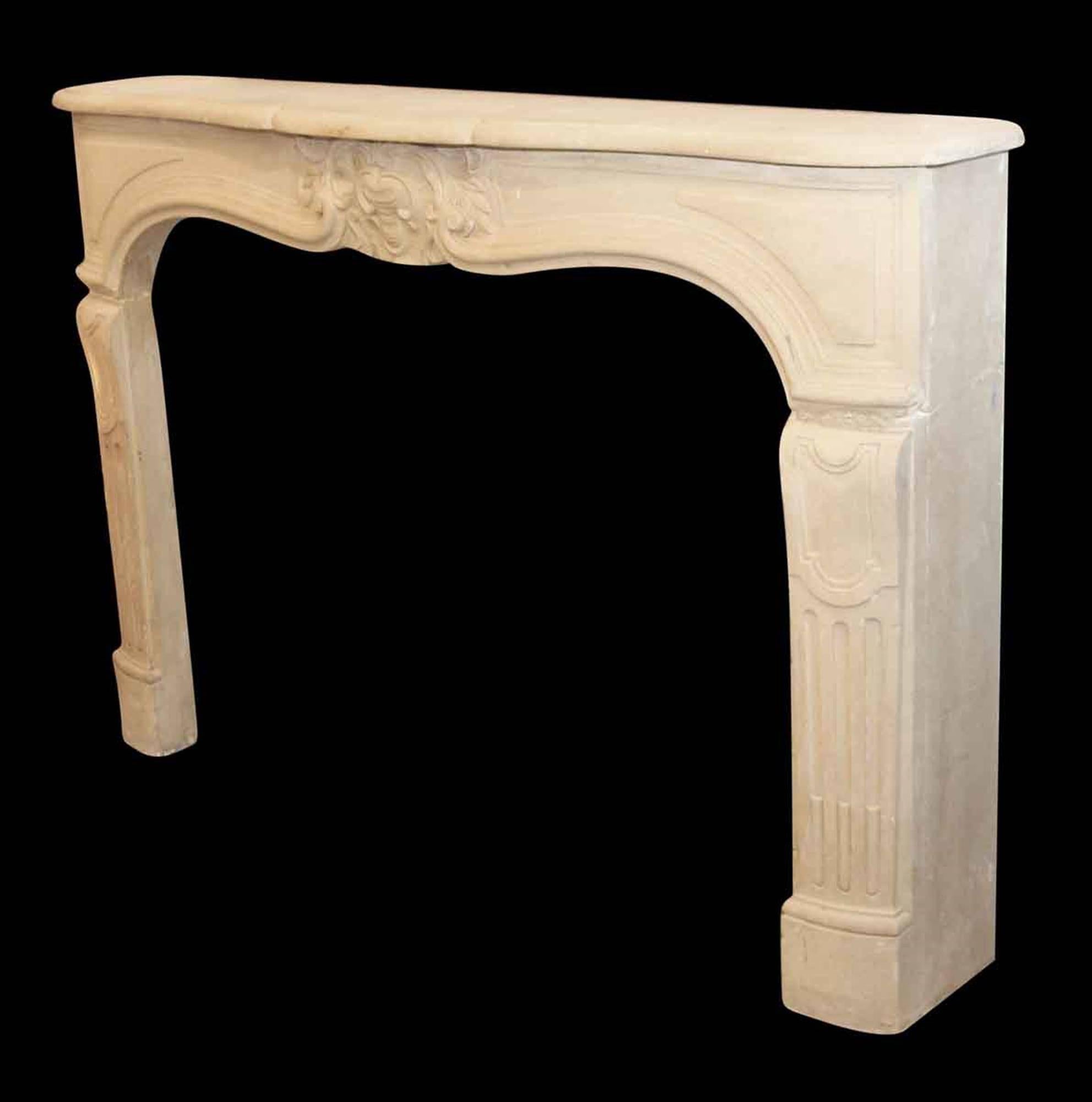 Neoclassical style tan limestone mantel with carved details. This can be seen at our 5 East 16th St lotion on Union Square in Manhattan.