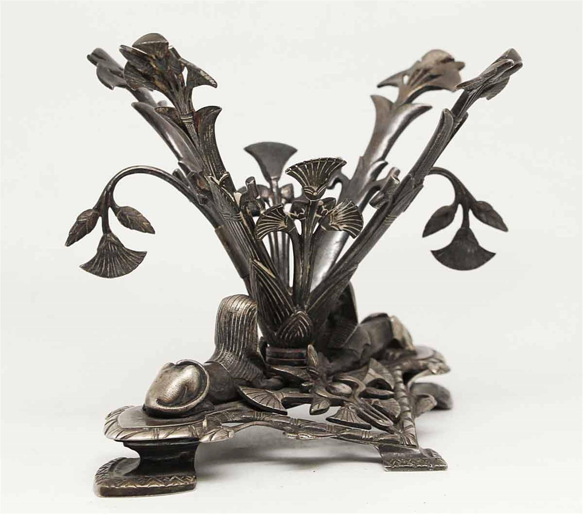 This is an 1878 Elkington & Co. silver plated Stand in an Egyptianesque style. The openwork base is modeled with two sphinxes and mythical creatures amidst stylized foliage, with four supports rising from the center, decorated with further foliate