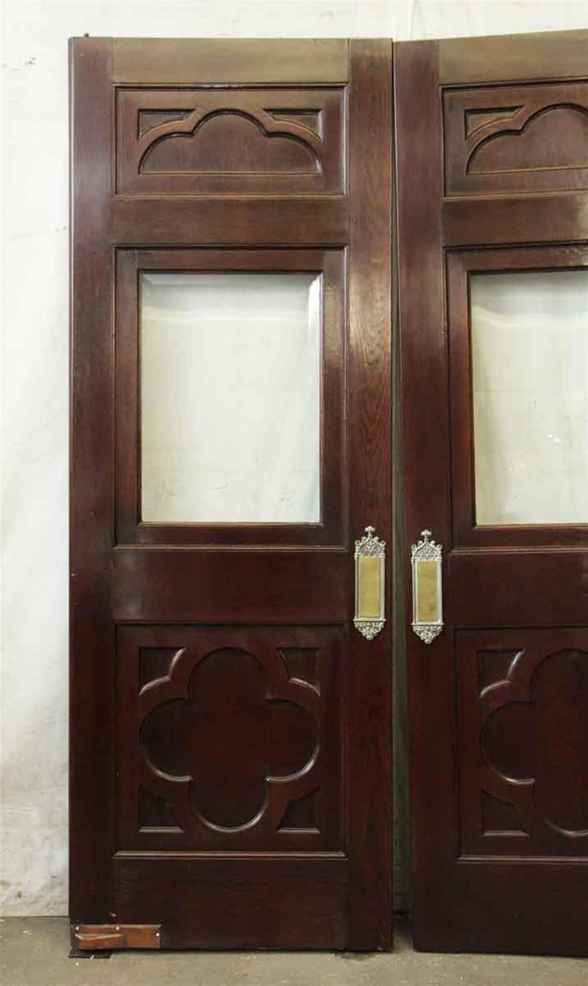 From the 1910s clover burled doors with beveled glass and solid brass hardware. Sold as a pair. These can be seen at our 400 Gilligan St location in Scranton, PA.