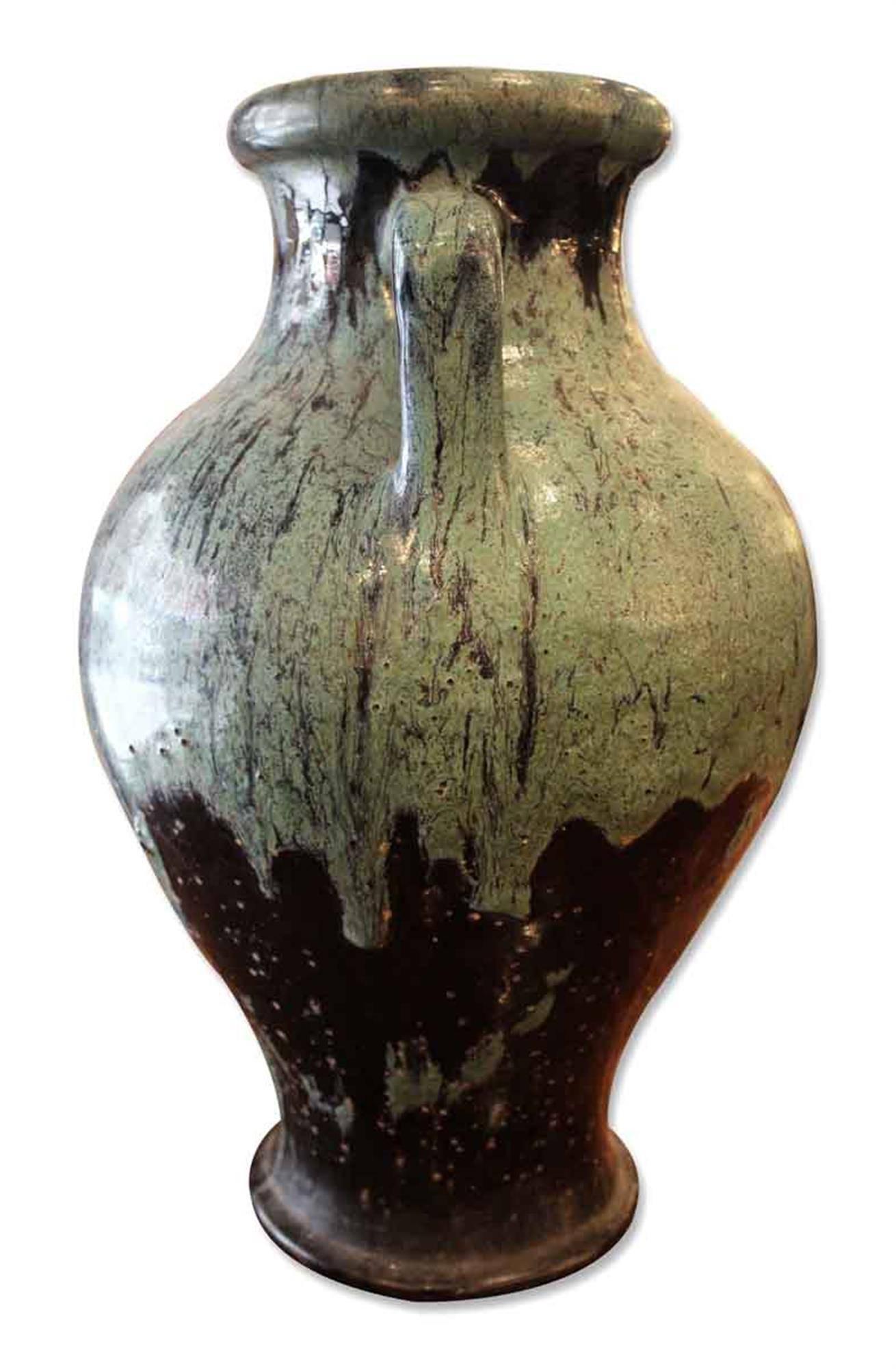 Hand thrown stone urn or vase with applied handles and drips breaking into a blue green color. This can be seen at our 400 Gilligan St location in Scranton, PA.