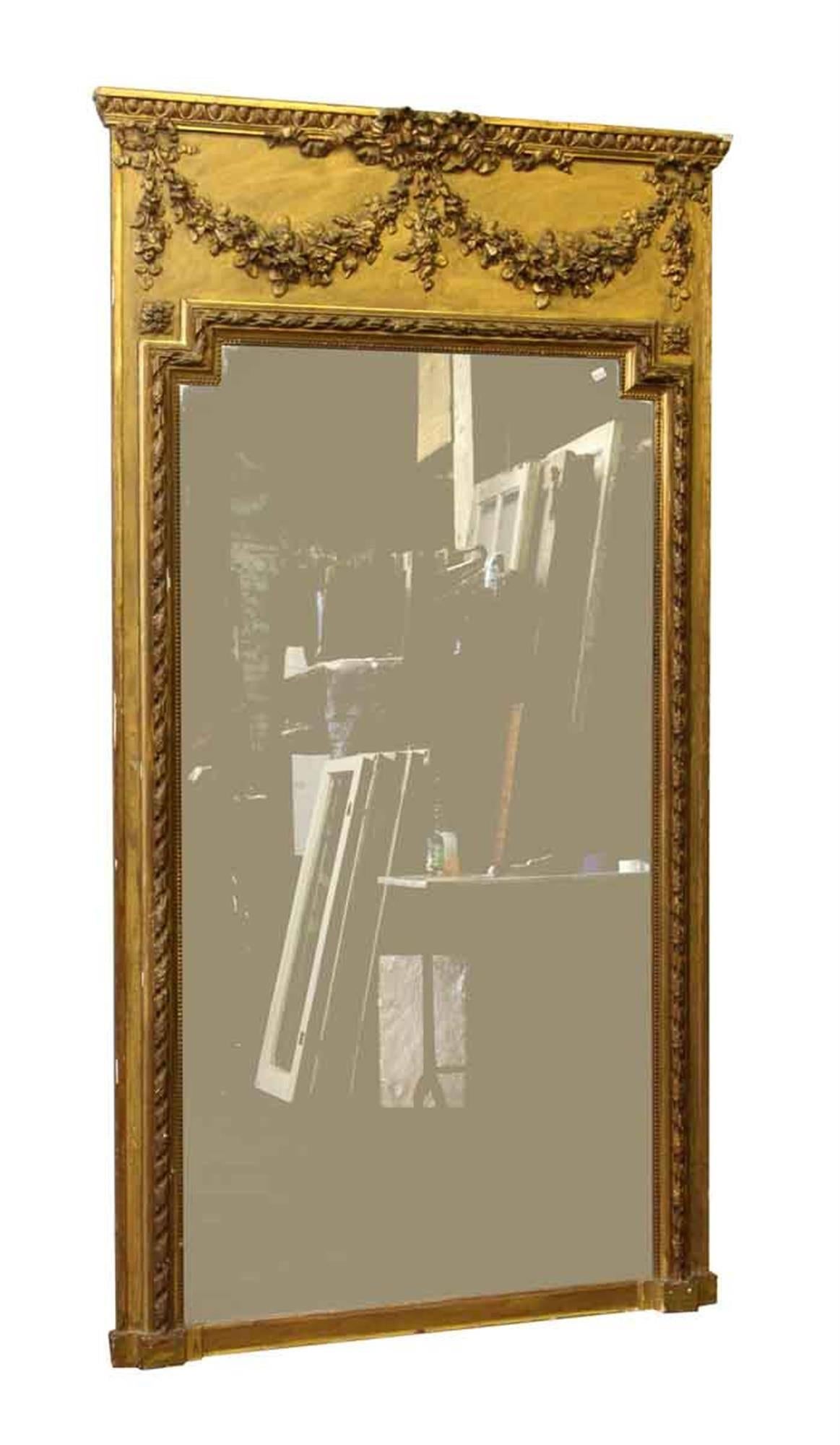 1880s antique French plaster over wood gilded mantel mirror with beaded, floral swag, egg and dart details. Some wear-see pictures. This can be seen at our 302 Bowery location in Manhattan.
