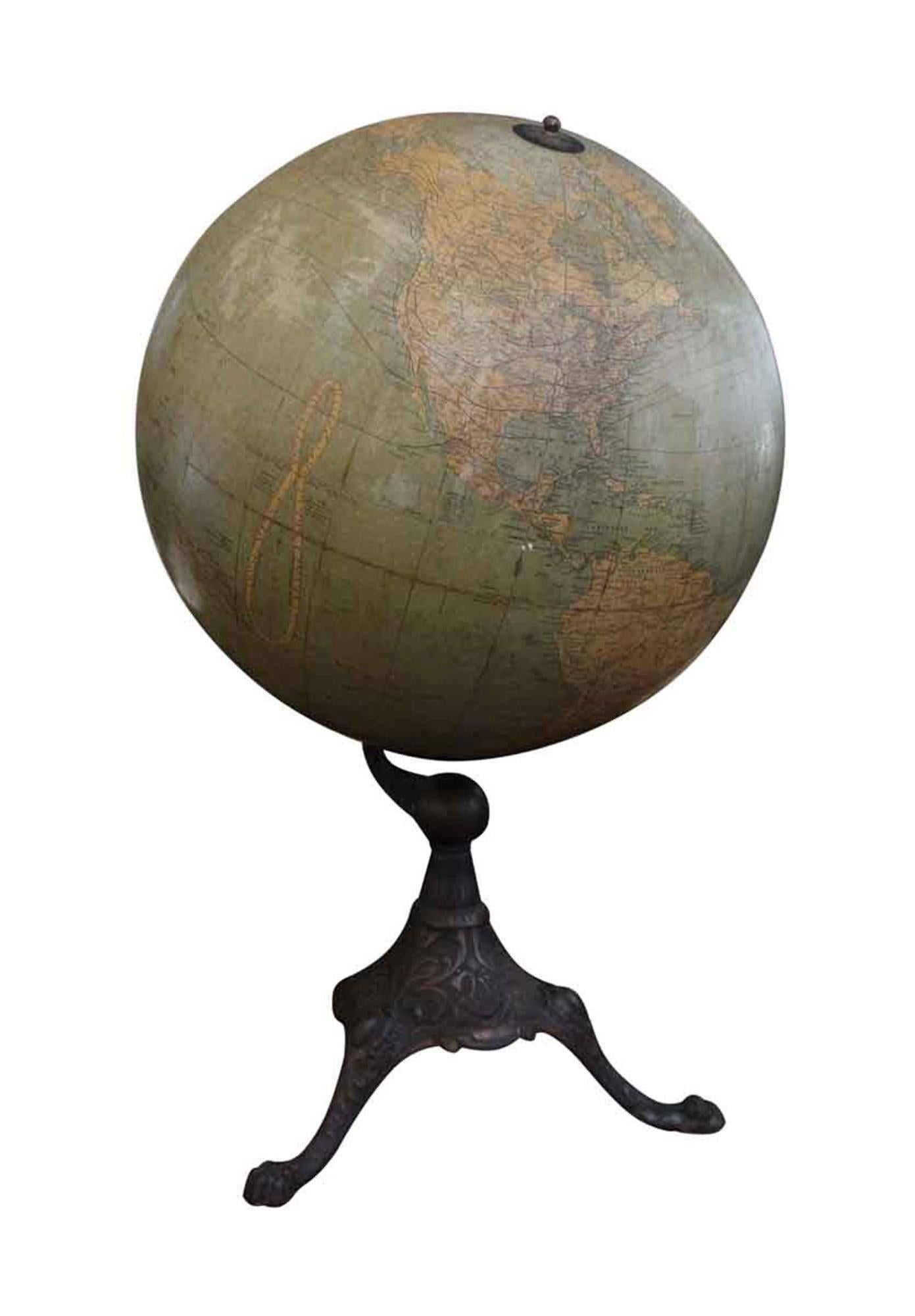 Terrestrial globe from the late 1920s. The metal globe is set on a decorative cast iron base, and was likely used in a classroom or library setting. This can be seen at our 2420 Broadway location on the upper west side in Manhattan.