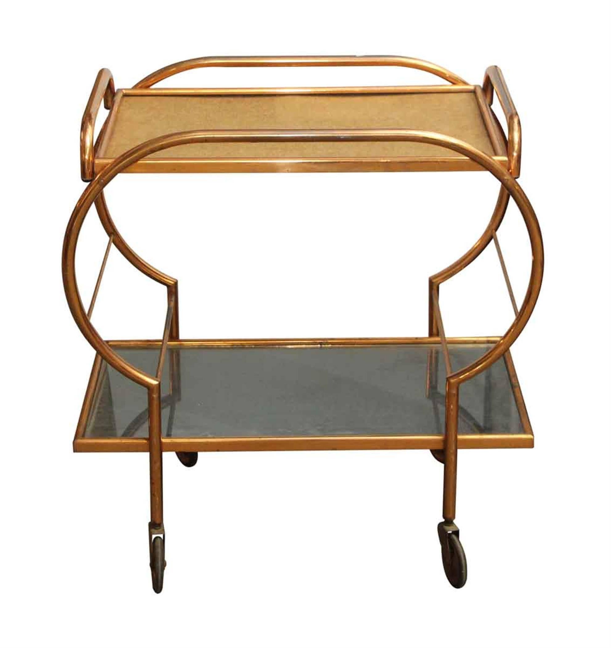 Vintage Mid-Century Modern style bar cart with a copper wash and removable top tray, 1970s, France. This can be seen at our 302 Bowery location in Manhattan.
