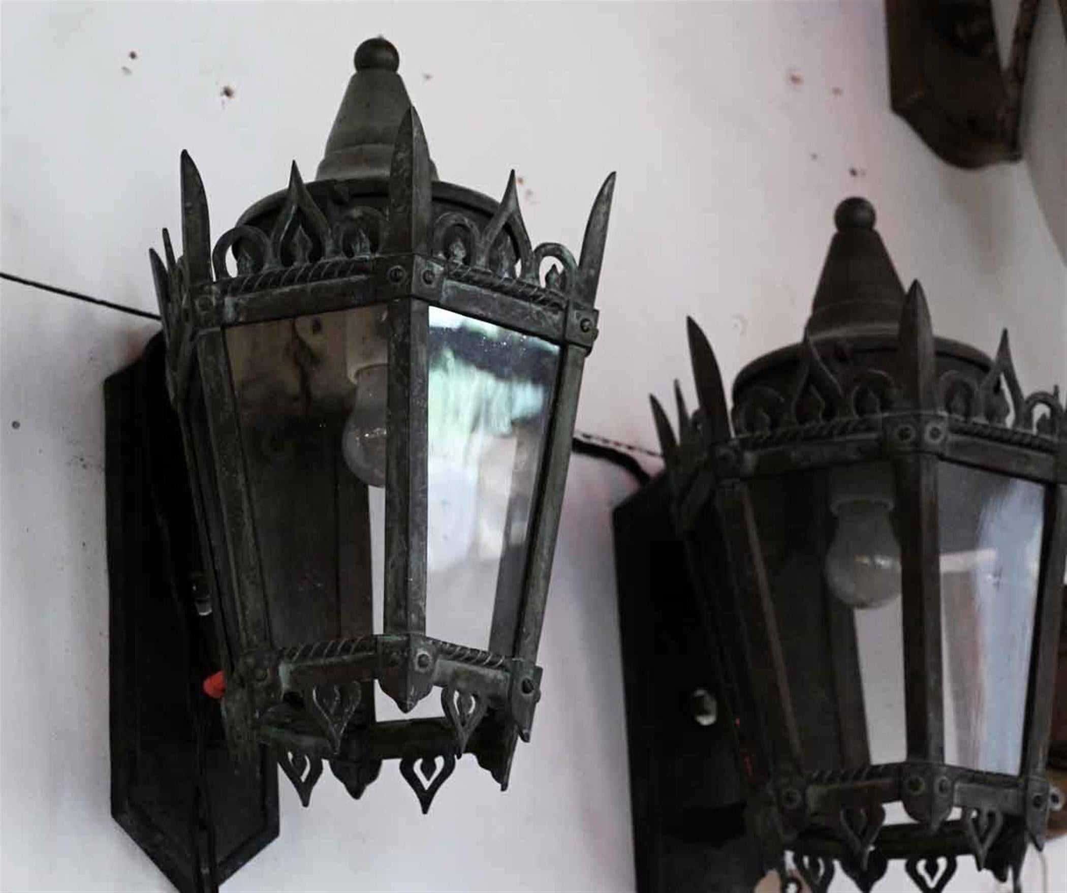 1930s pair of Art Deco bronze exterior sconces with original glass panels and patina. All glass panels can be replaced. This can be seen at our 2420 Broadway location on the upper west side in Manhattan.