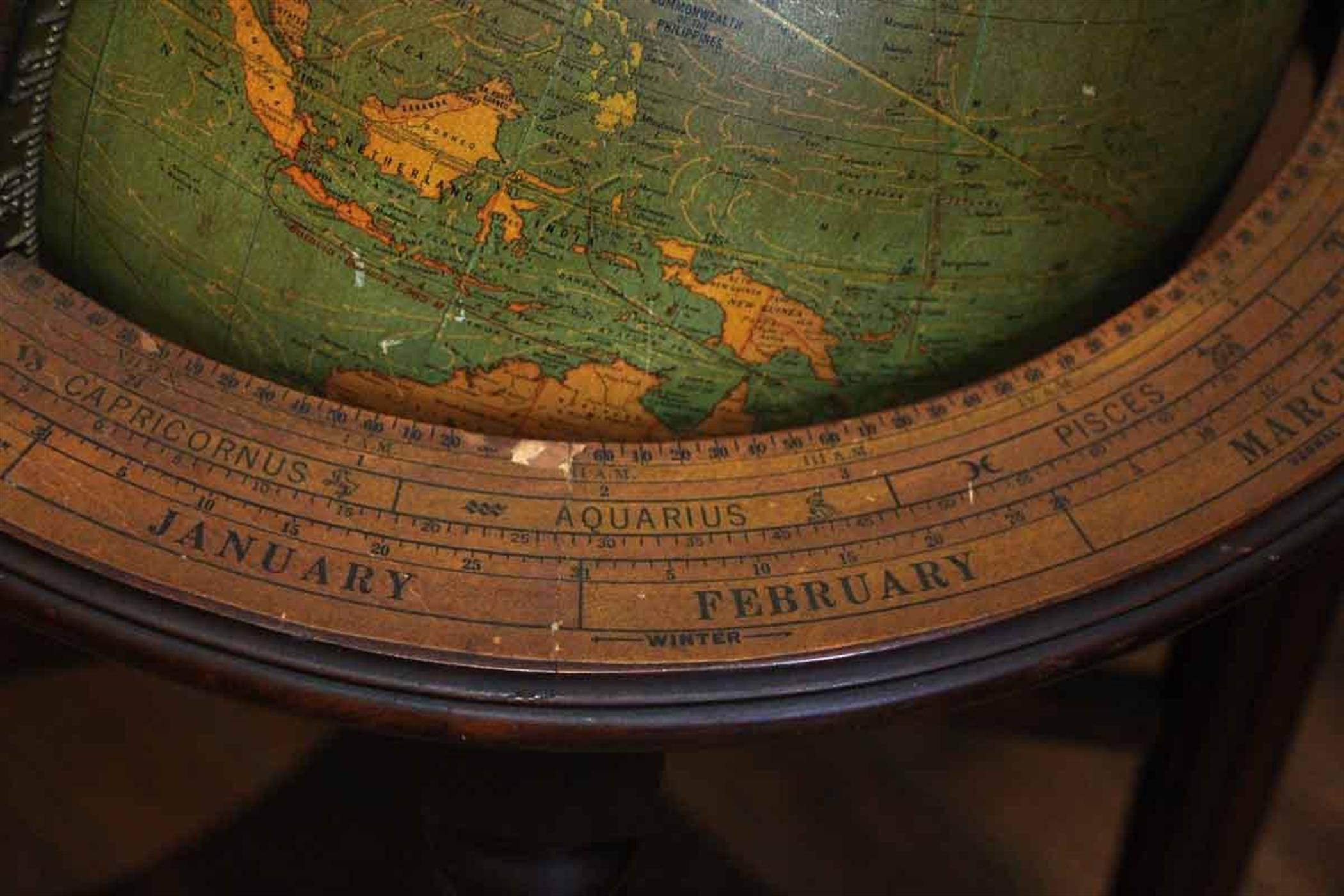 Elegant lighted glass library globe made by George F. Cram Co. in the 1930s. Set on a mahogany Stand with fluted, turned legs. Founded in 1869, the George F. Cram company has outlived almost all other 19th century map publishers to remain a major