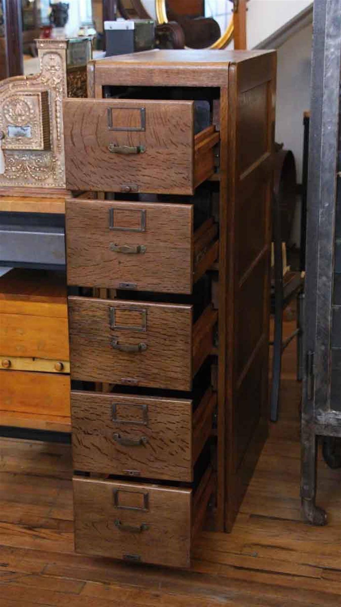 A handsome antique oak filing cabinet manufactured by “Library Bureau Sole Makers”, a company founded by Melville Dewey. This solid oak cabinet was produced circa 1890-1927 and features five flush mount drawers with original brass pulls and label