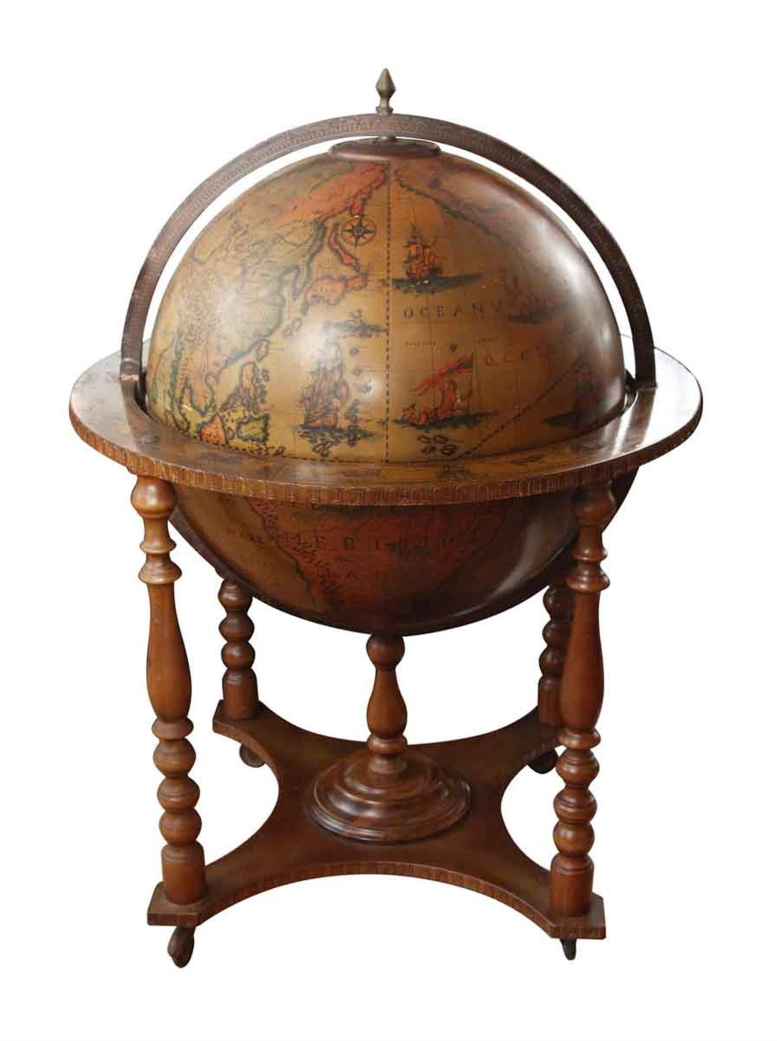 1970s Italian Renaissance style standing world globe enclosed in an ornately decorated wooden stand. Stylized continents on the outside and sky constellations inside. The globe opens to reveal a spacious rotating dry bar inside. This can be seen at