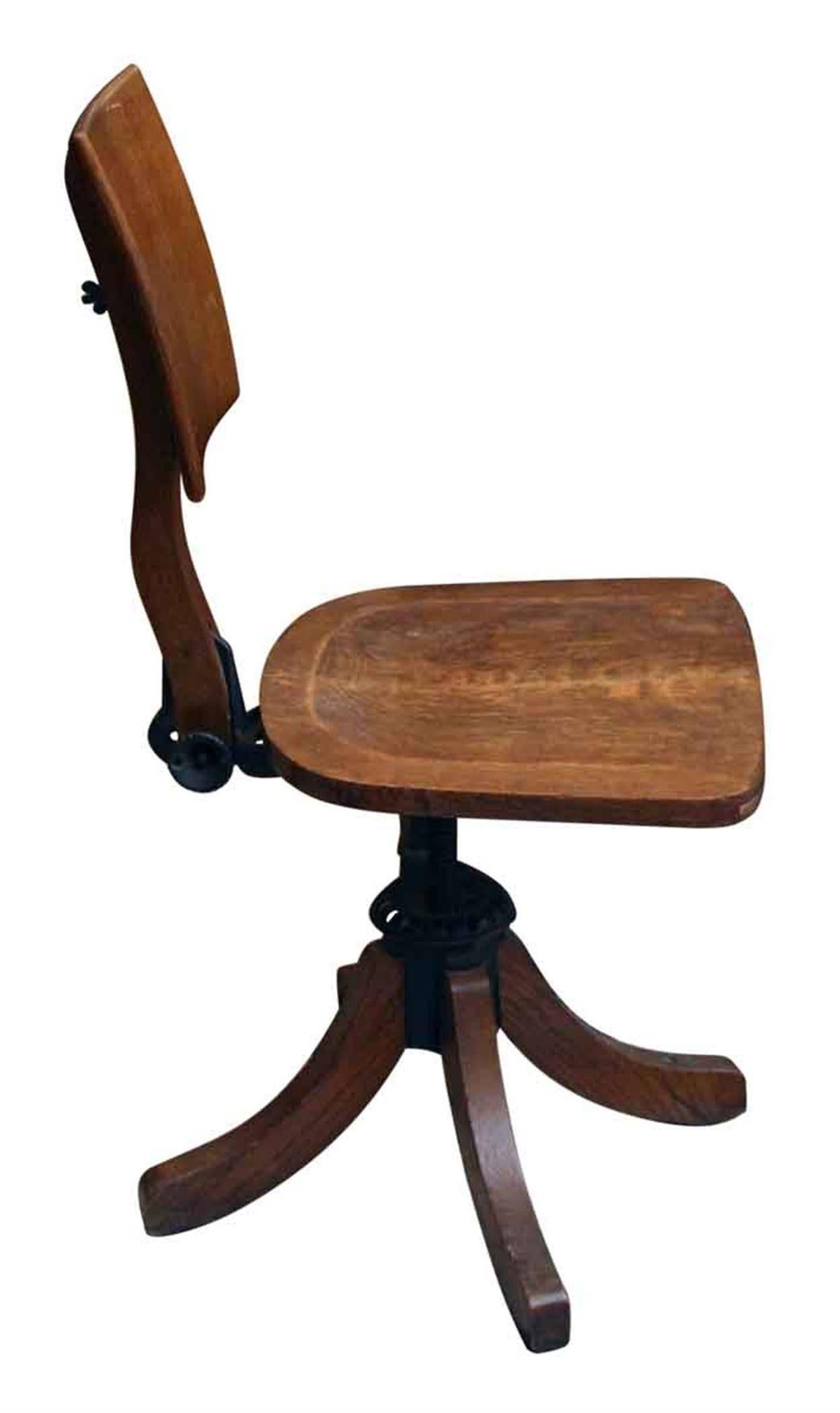 1920s dark wood tone oak office chair with a unique back and adjustable settings. This can be seen at our 5 East 16th St location on Union Square in Manhattan.
