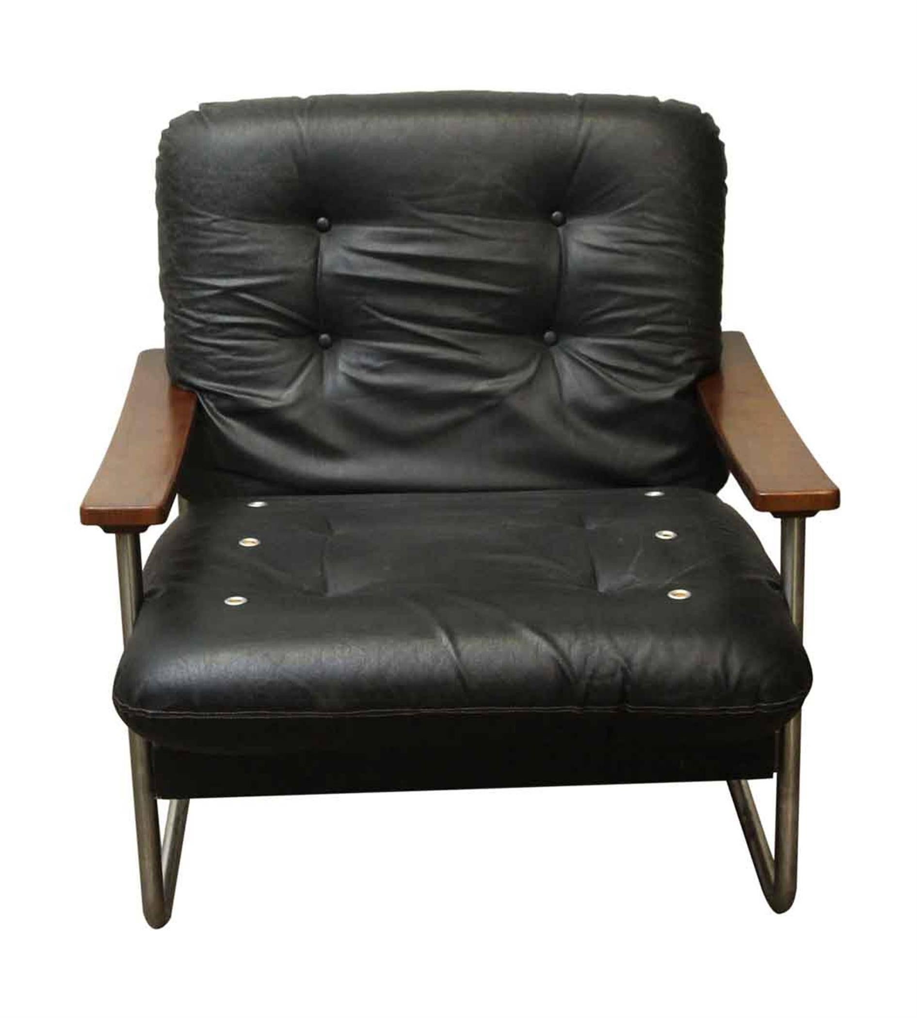 1960s black leather Italian armchair with wooden arms and a chrome-plated steel base. Made by Mobiltecnica. Three available at time of posting. Priced individually. This can be seen at our 2420 Broadway location on the upper west side in Manhattan.
