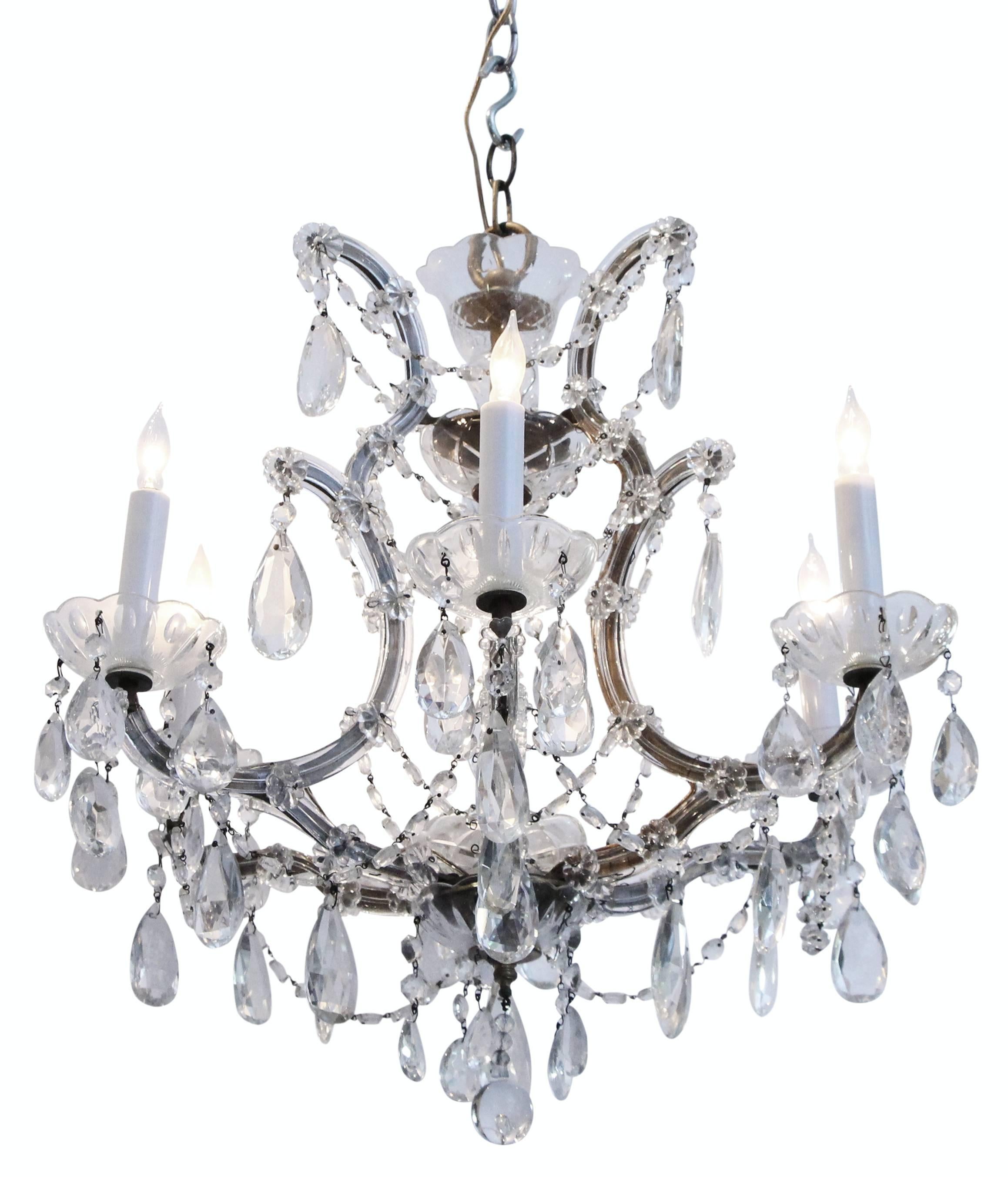 Six-arm crystal chandelier with numerous hanging crystals and crystal arms. This fixture is also embellished with a large hanging finial and multiple beaded chains of crystal. This item can be seen at our store at 5 East 16th Street on Union Square