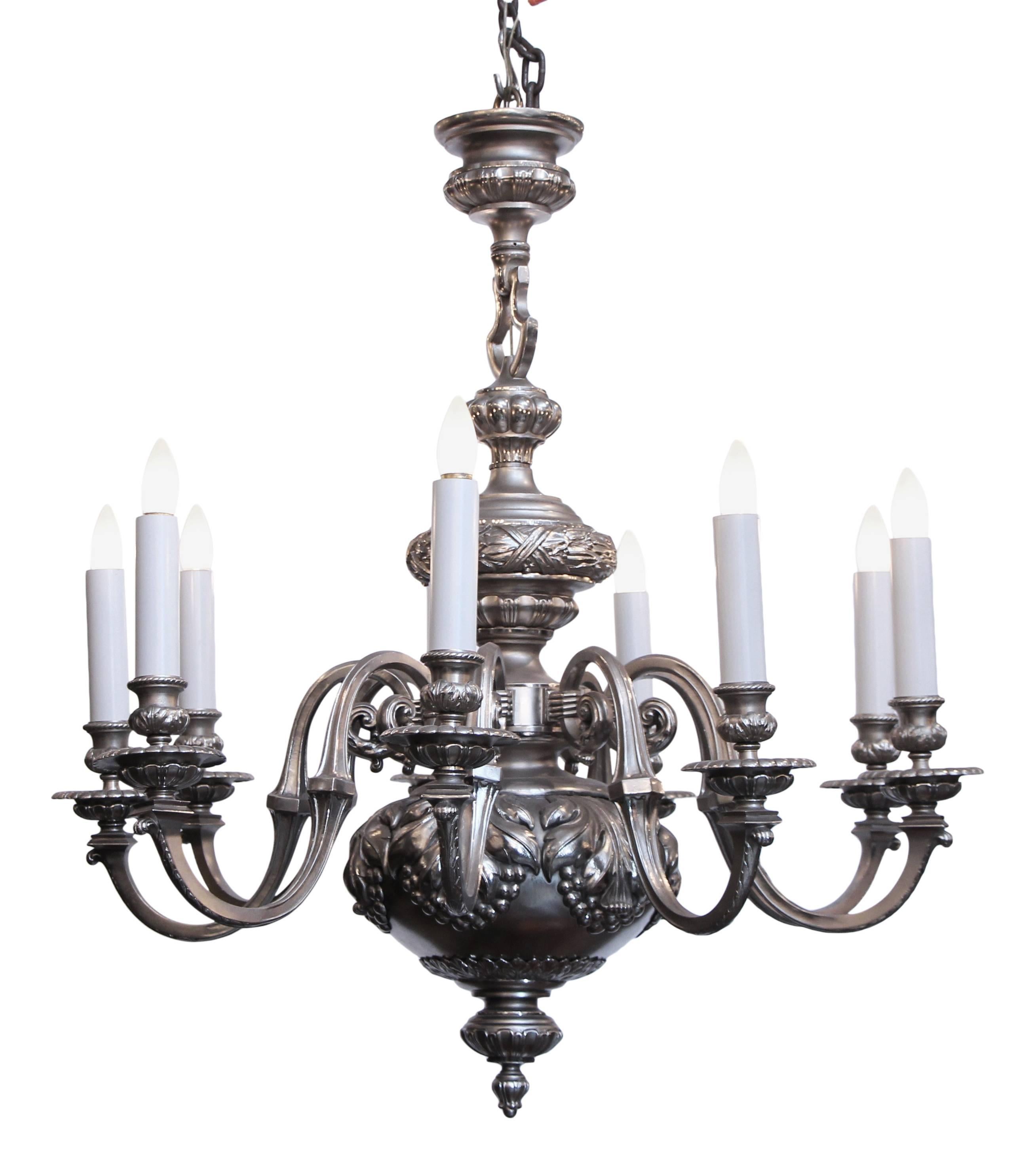 Silvered bronze chandelier with detailed laurel leaf and fruit castings. This is English made in the first quarter of the 20th century. 9 lights. Cleaned and rewired.  This can be seen at our 333 West 52nd St location in the Theater District West of