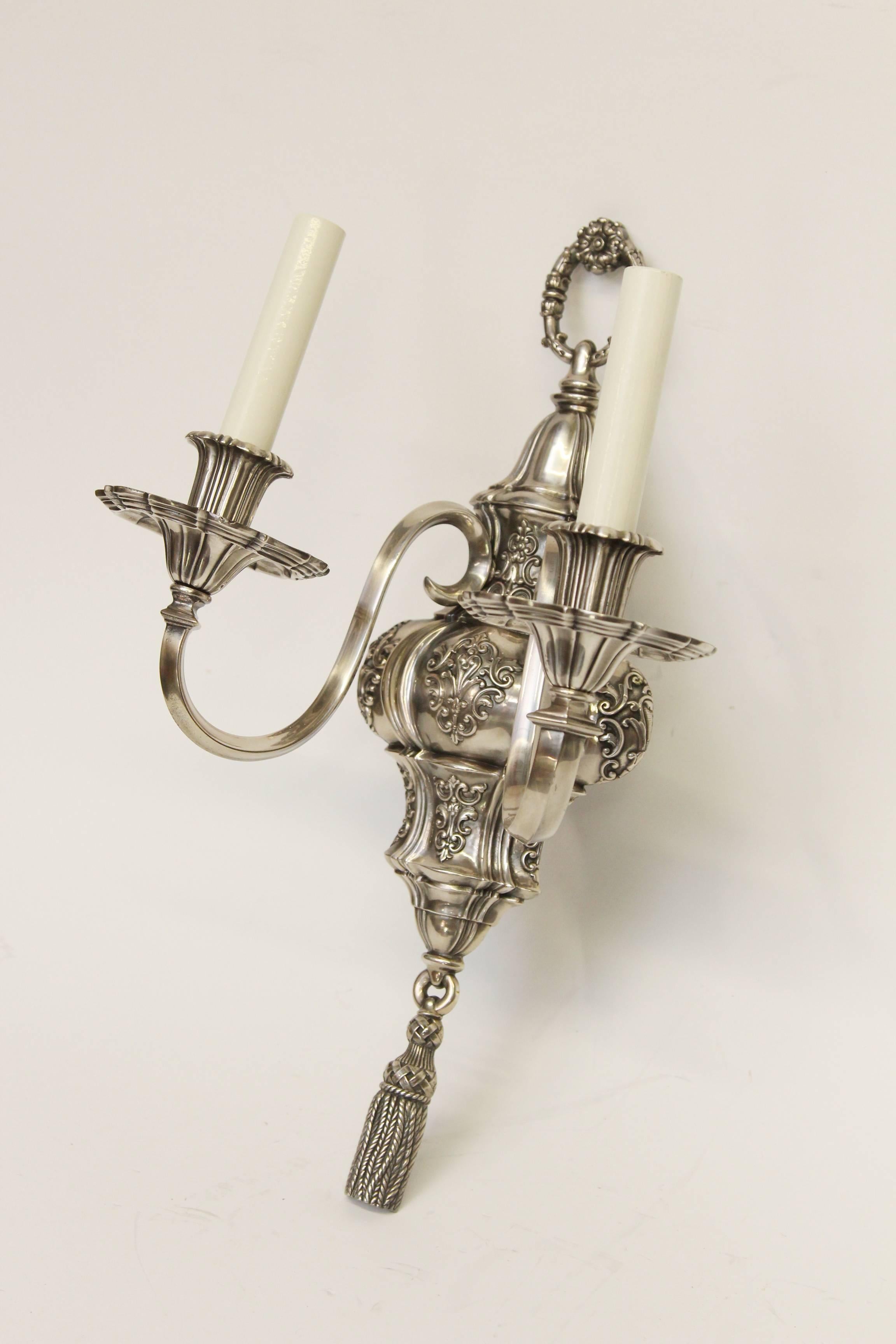 1920s pair of ornate Georgian EF Caldwell two-arm silver over bronze sconces. This can be viewed at one of our New York City locations. Please inquire for the exact address.