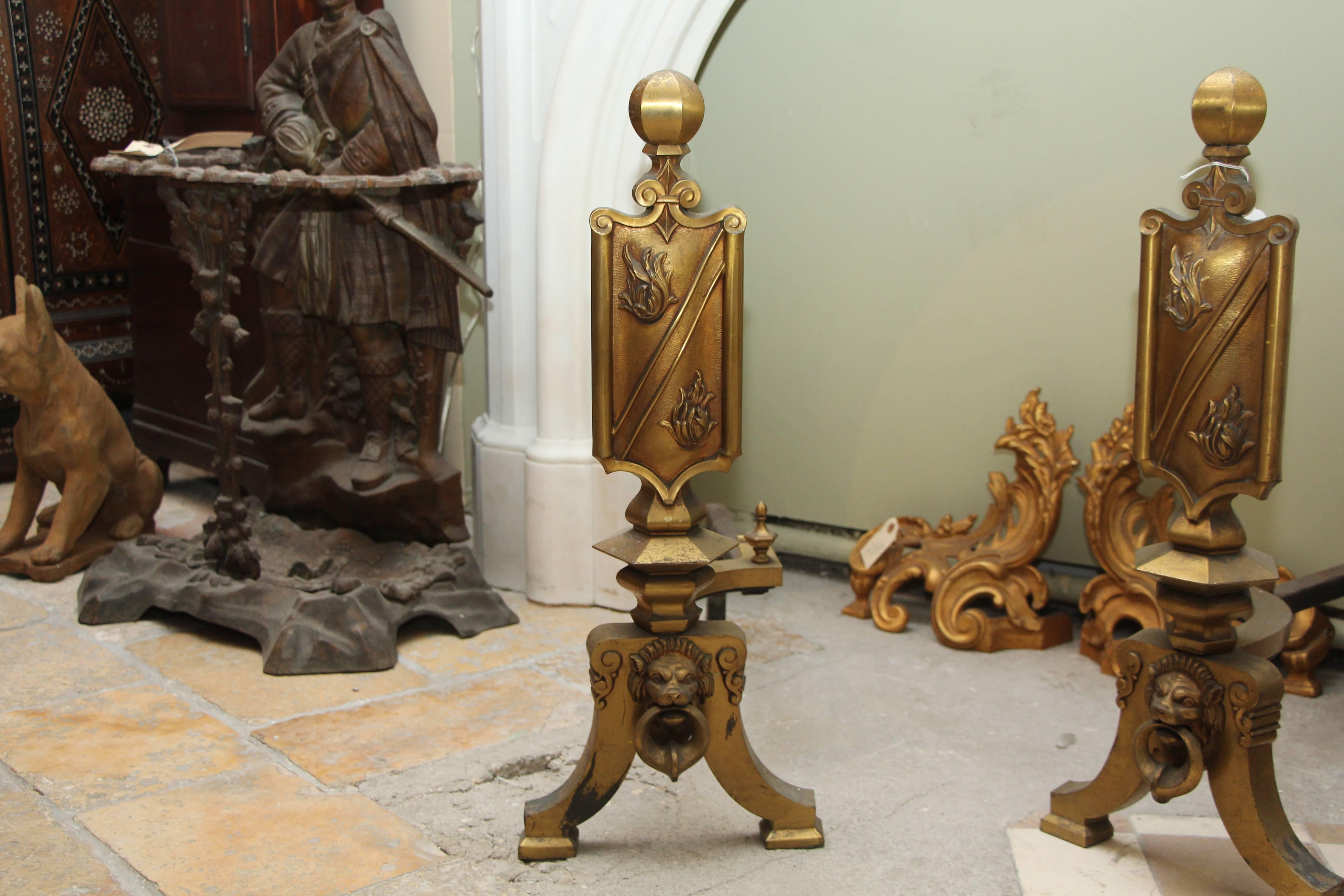1920s French figural andirons with shield and lion head detail in gilded bronze. Priced as a pair. These can be viewed at our 5 East 16th St, Union Square location in Manhattan.