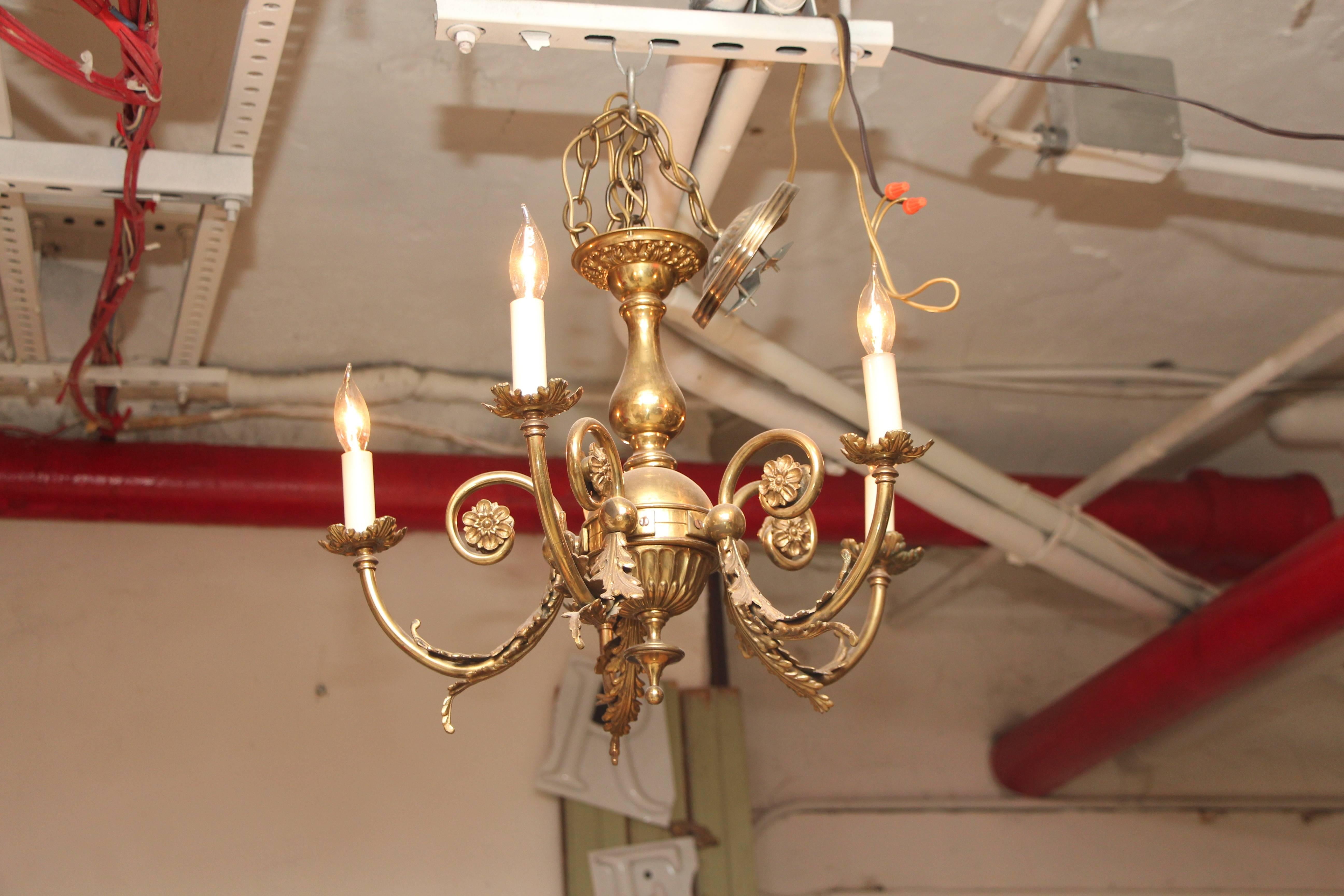 1920s petite brass five-arm chandelier with rosettes and leaf details. Simple but elegant. This item can be viewed at our 5 East 16th St, Union Square location in Manhattan.