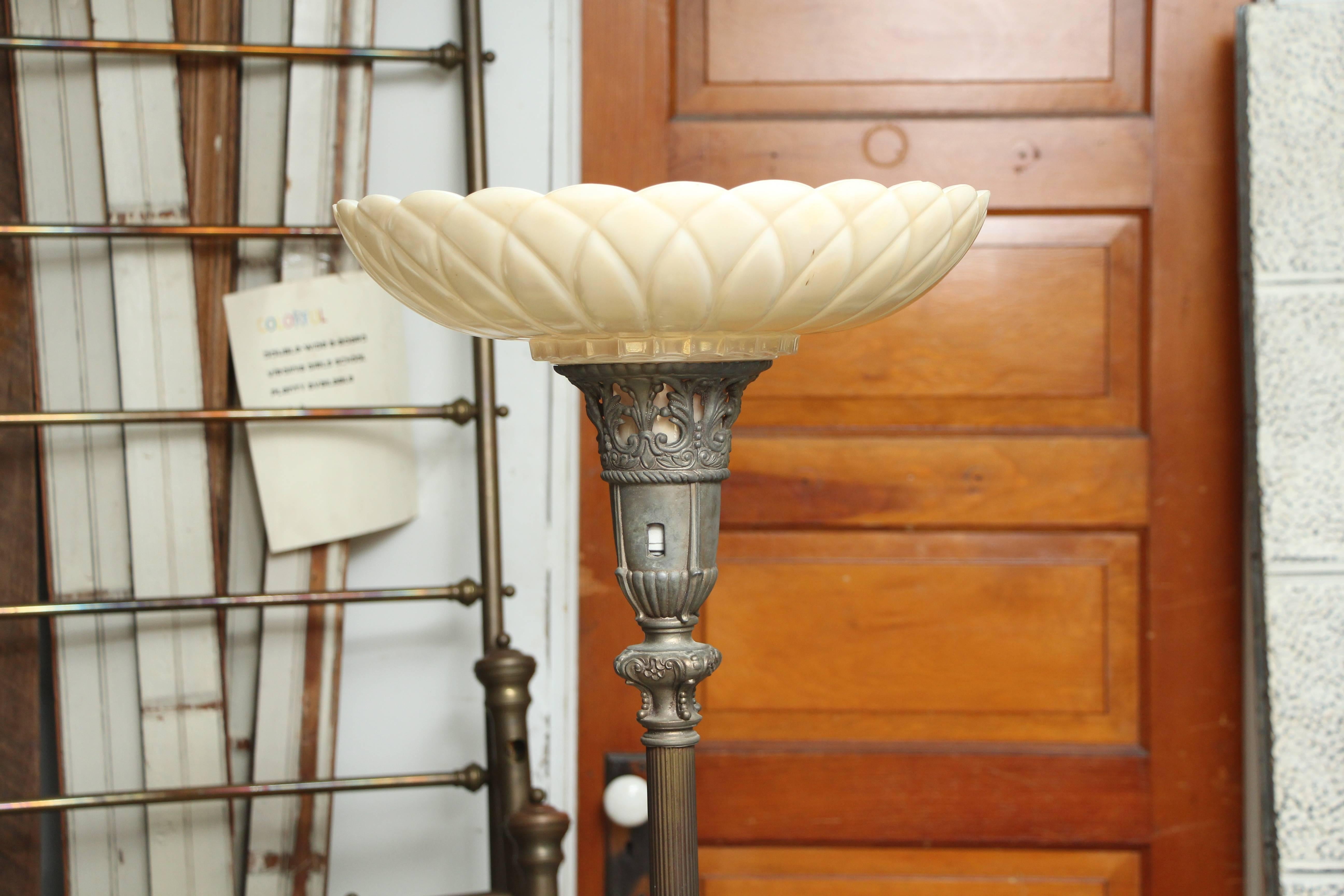 1930s Art Nouveau torchiere floor lamp with marble base. Molded glass upward shade throws a soft light on this torchiere lamp. Cast metal top and base have a flowing Art Nouveau detail. Fluted center column ends in a marble base. This item can be