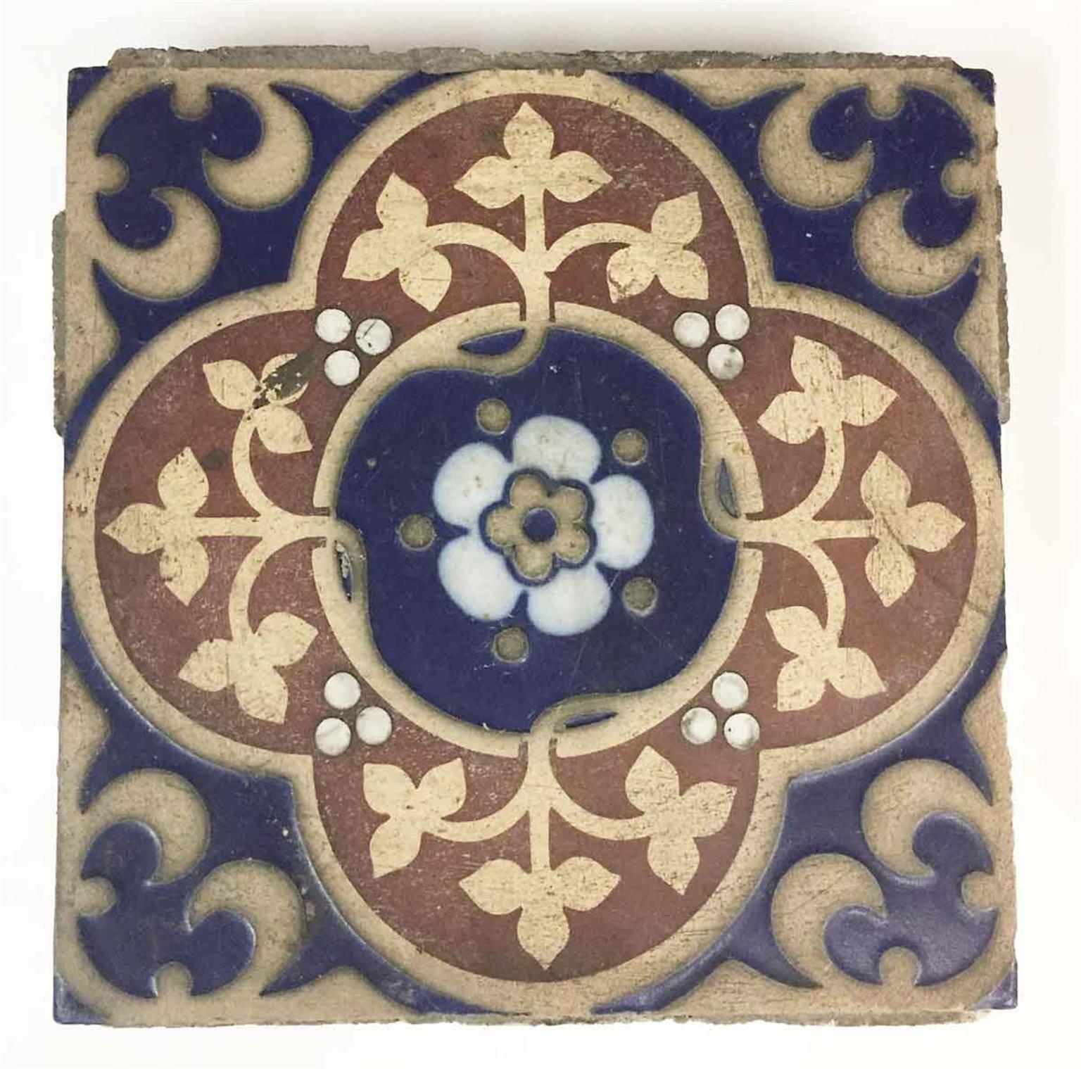 1920s encaustic Minton 'Stoke Upon Trent' tile floor. Red, blue, tan and white in color. Set includes nine flower leaf styles, 86 leaf styles and 45 flower styles of tile, calculating 22 square feet total, which is 139 total tiles. Some tiles have