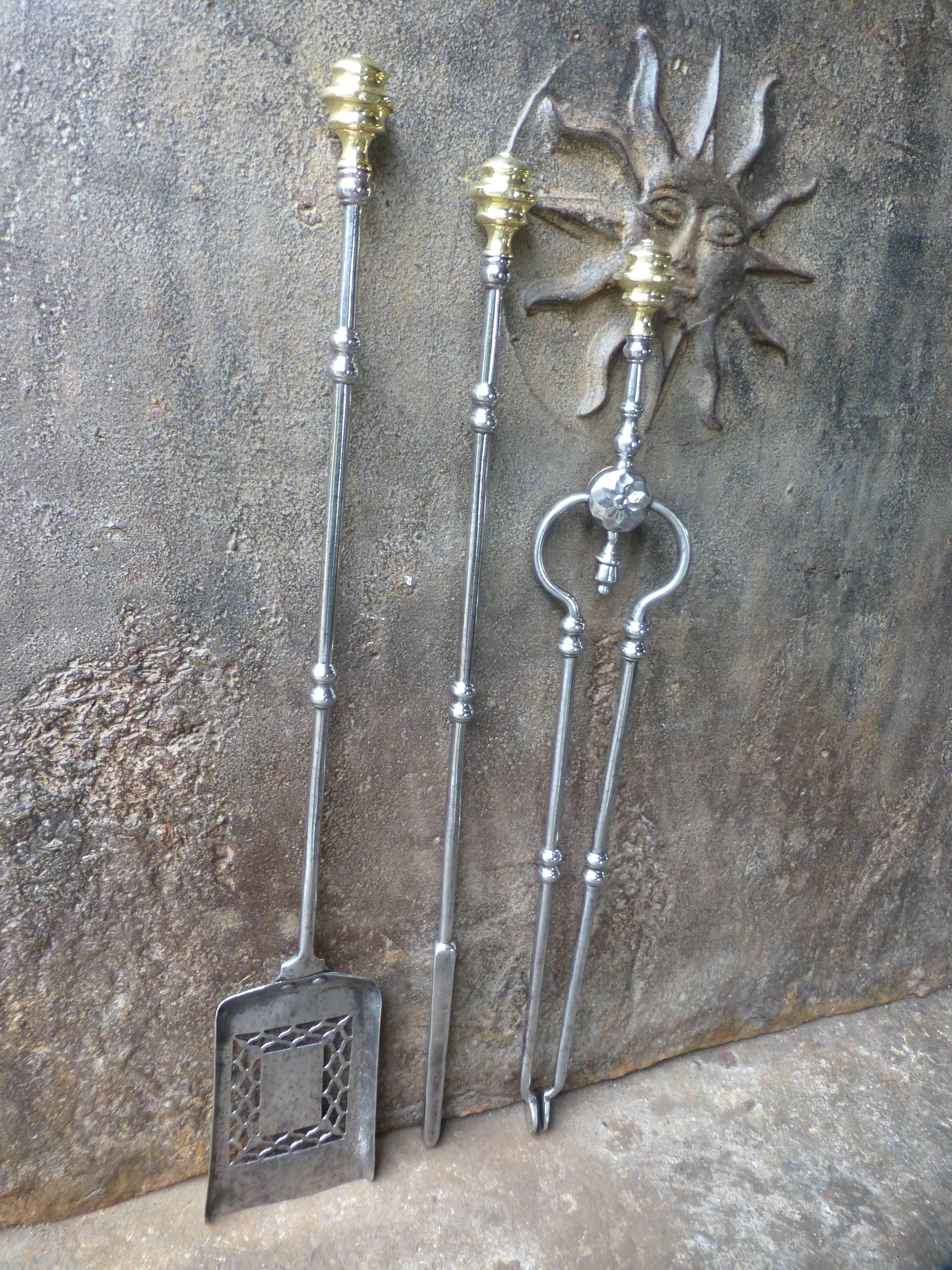 19th century English fireplace tool set of polished steel and brass.

 