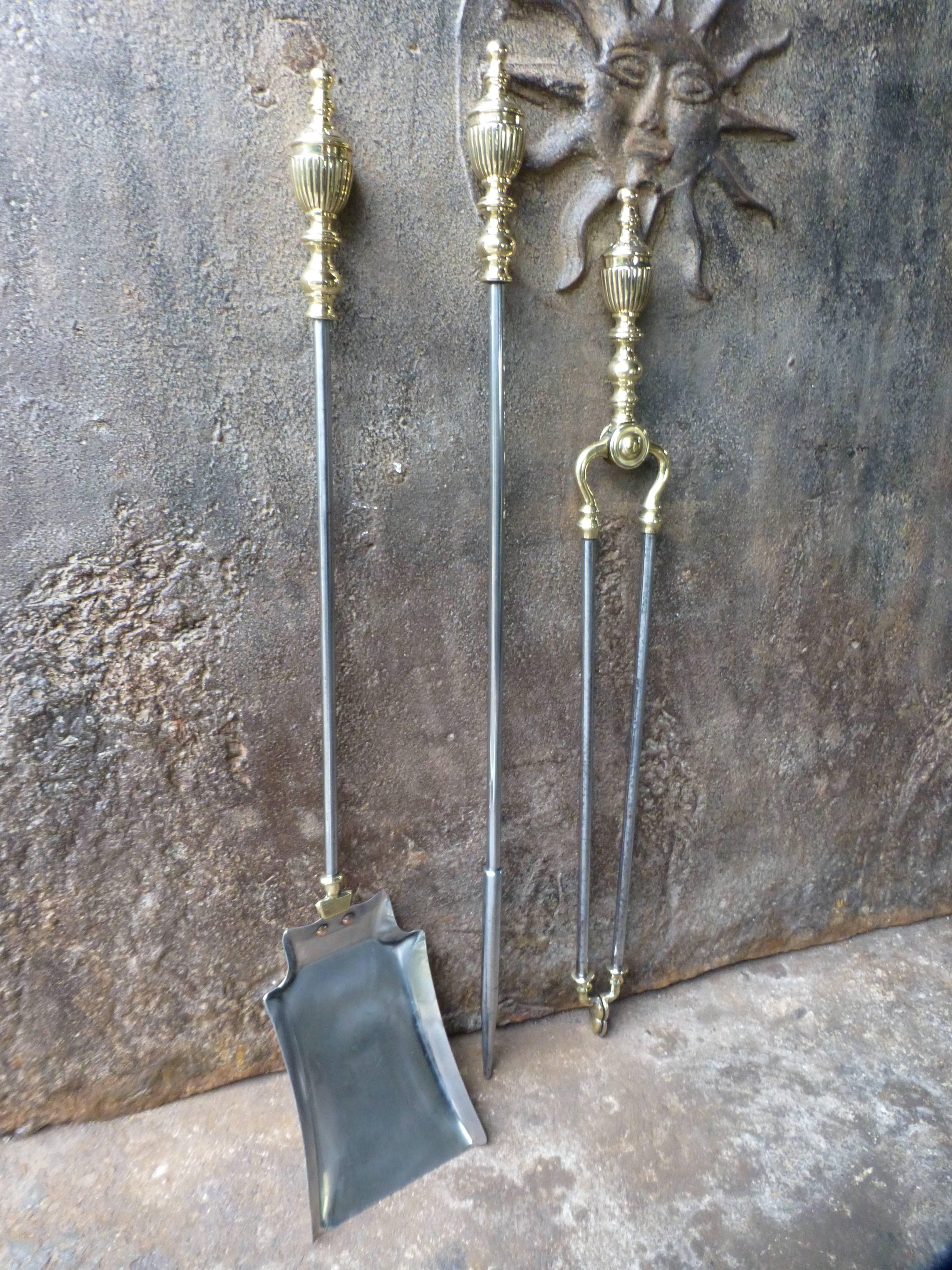 19th century English fire irons - companion set made of polished steel and brass handles and other details.
 