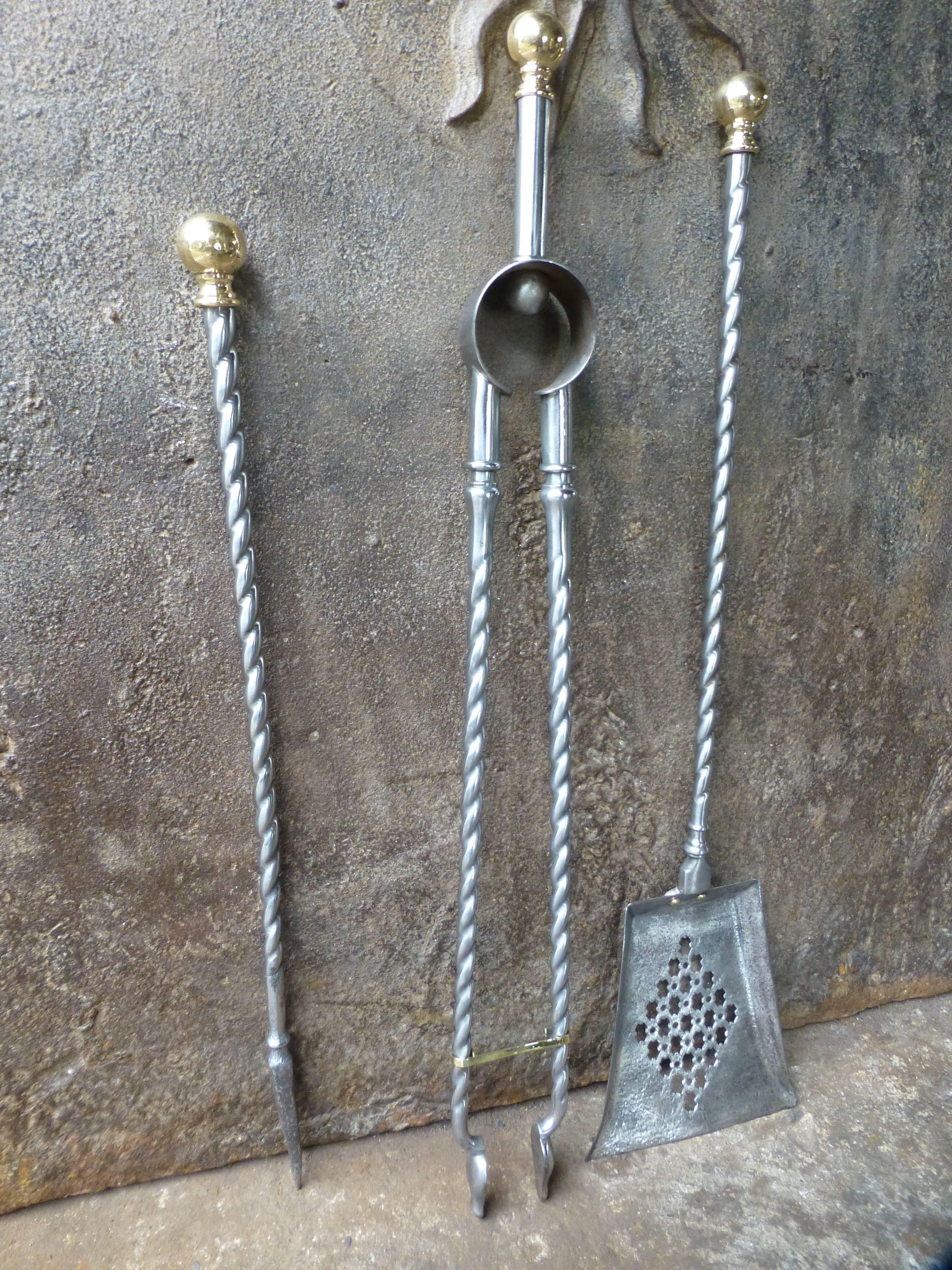 19th century English set of fire tools, fire irons made of polished steel with brass handles. Victorian period. The fireplace toolset is in a good condition.

