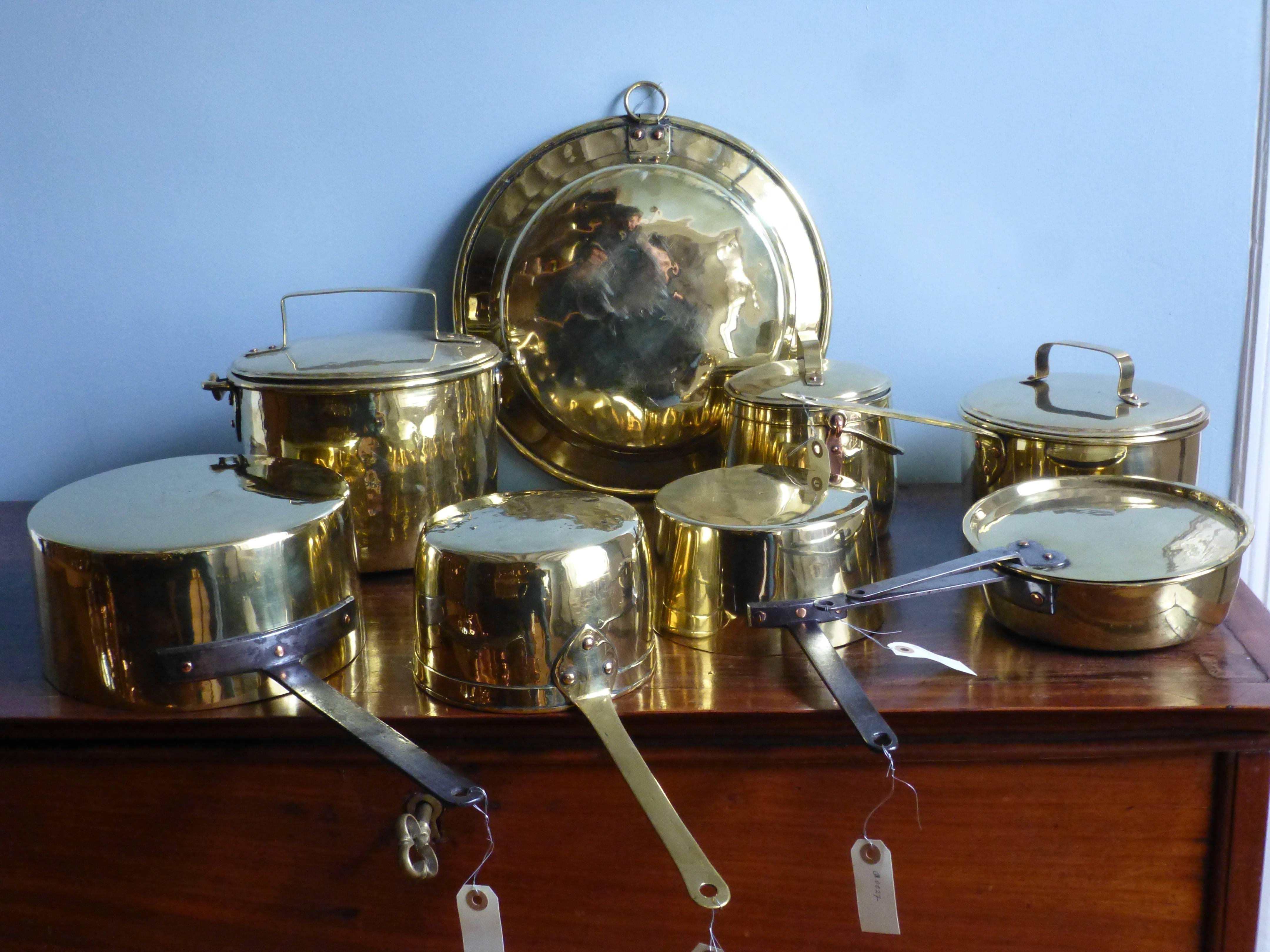 Beautiful set of decorative polished brass cooking pots consisting of two stock pots with lids, three sauce pans, a baking pan and one 18th century sauce pan with lid.
     
   