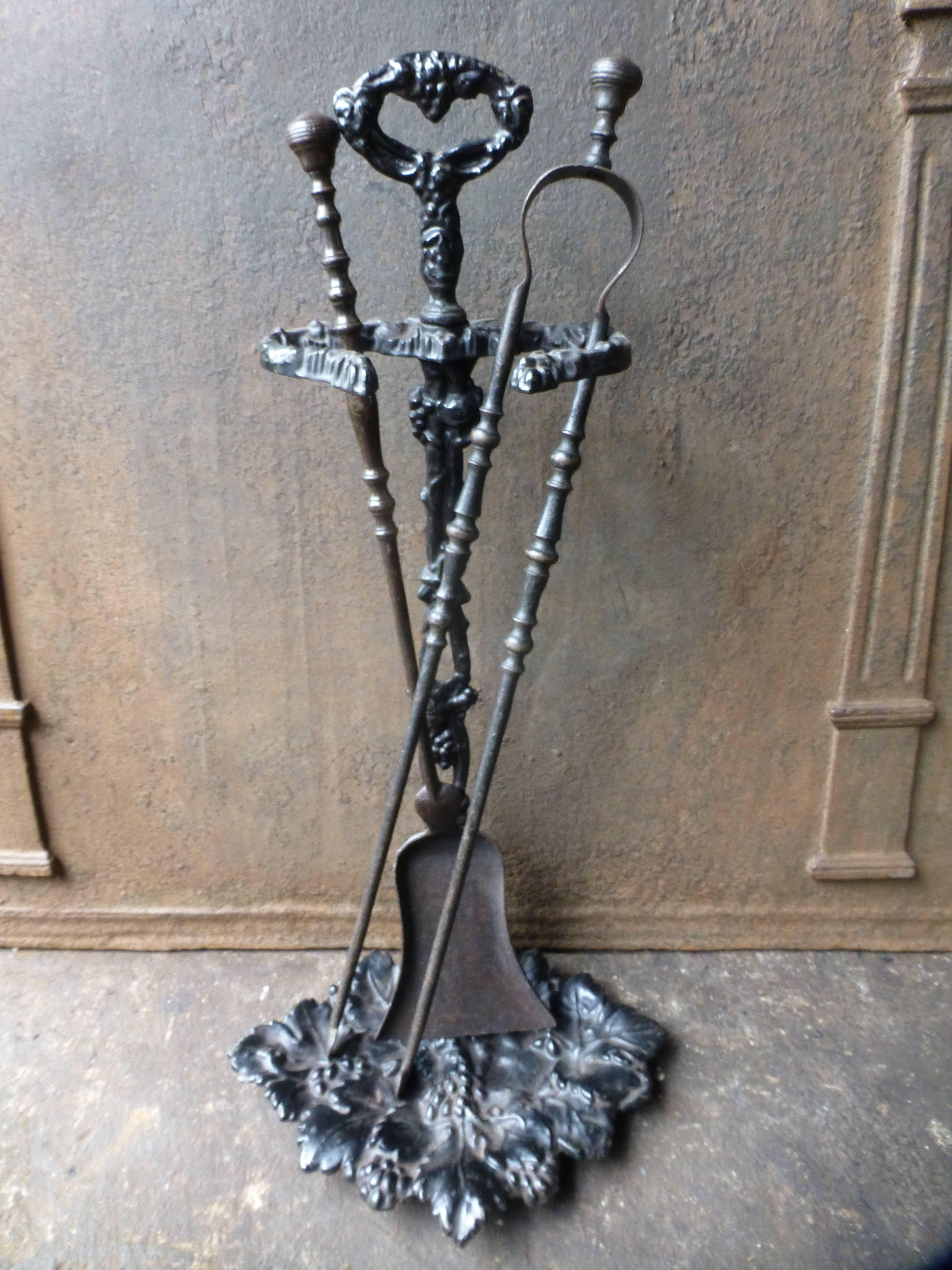 19th century French fire tools or fire irons, made of wrought iron (tools) and cast iron (stand).