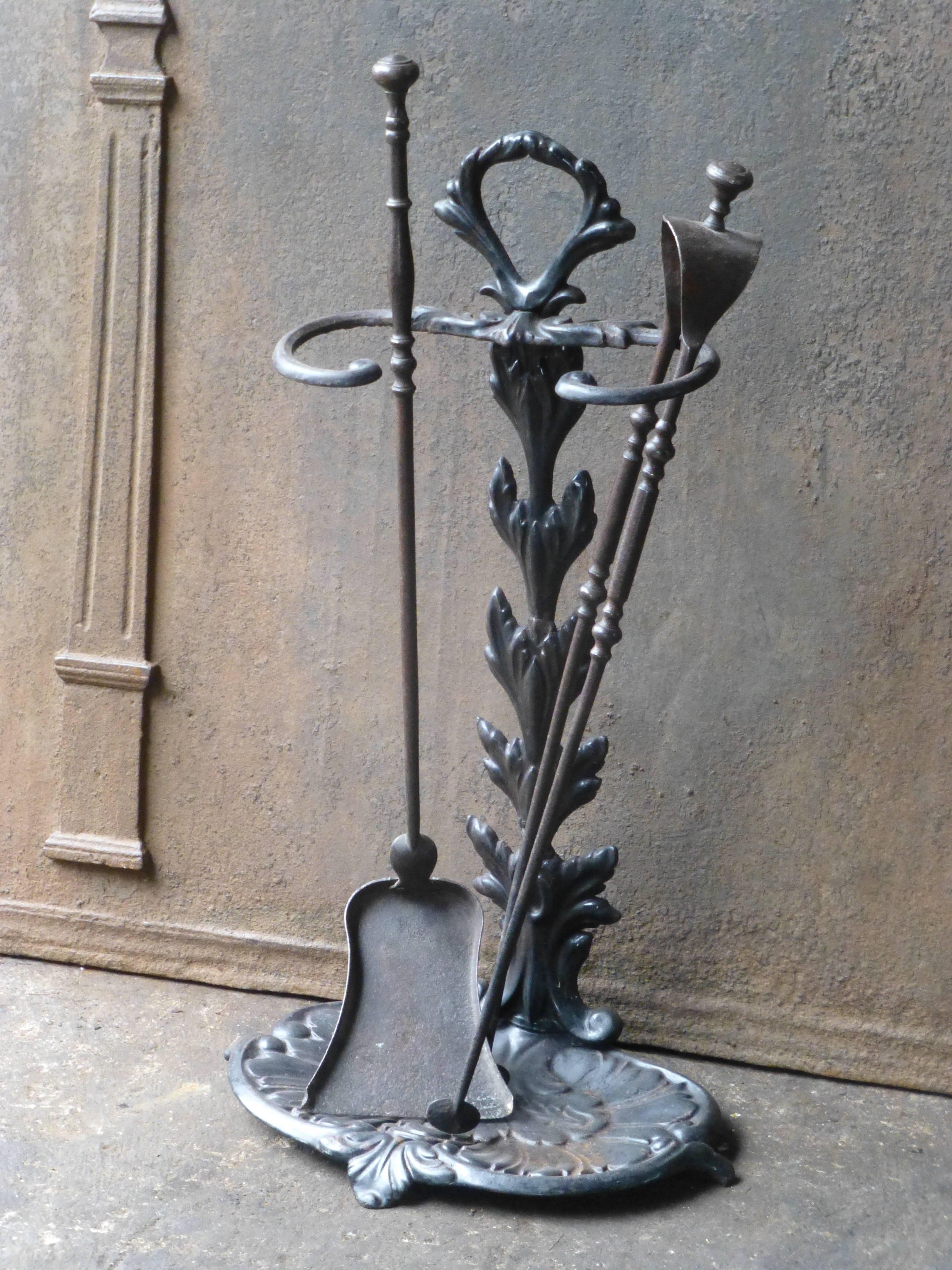 19th century French fire tools or fire irons made of wrought iron (tools) and cast iron (stand).