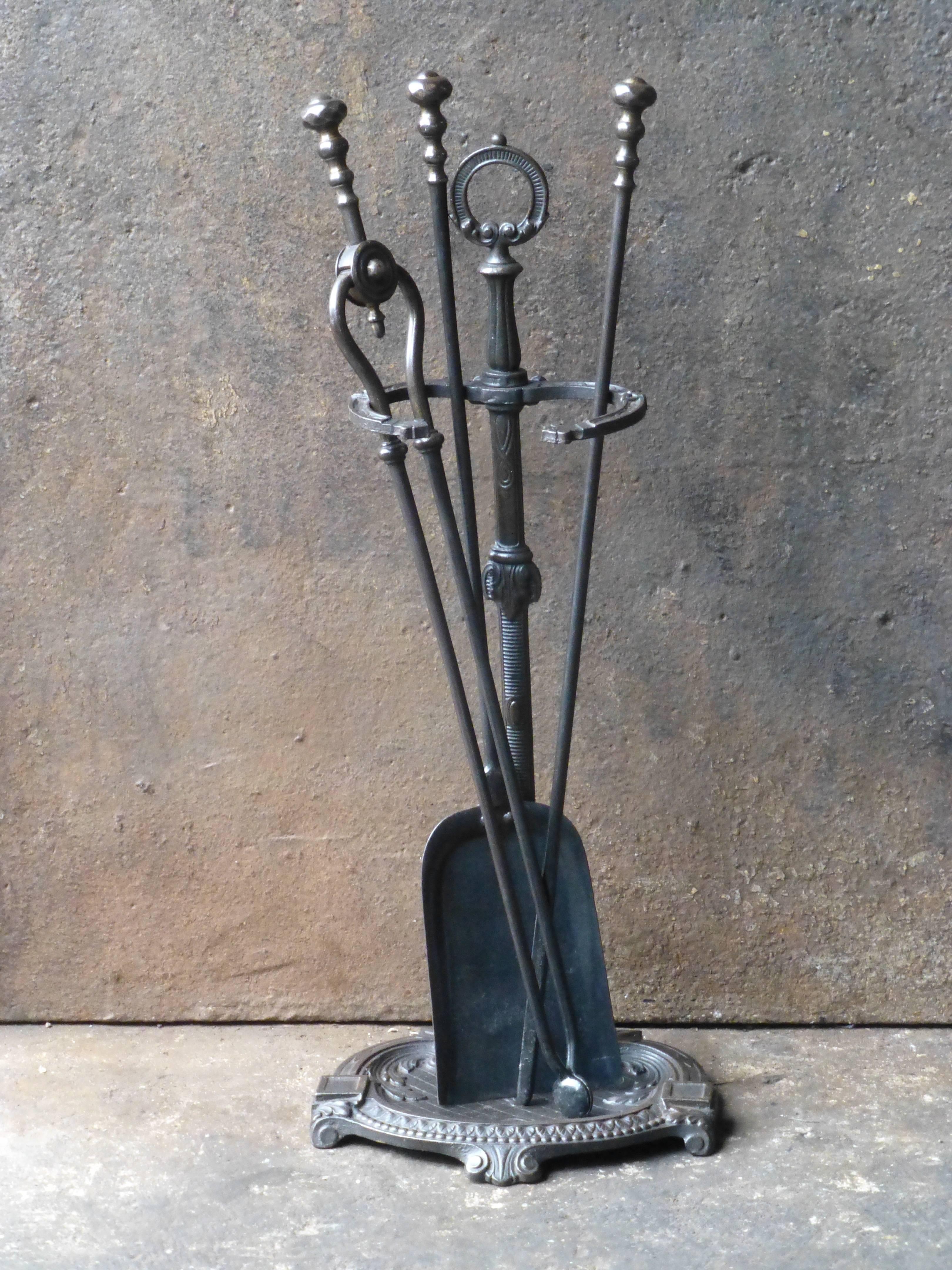 19th century English fireplace tool set. Fire tools made of wrought iron (tools) and cast iron (stand).