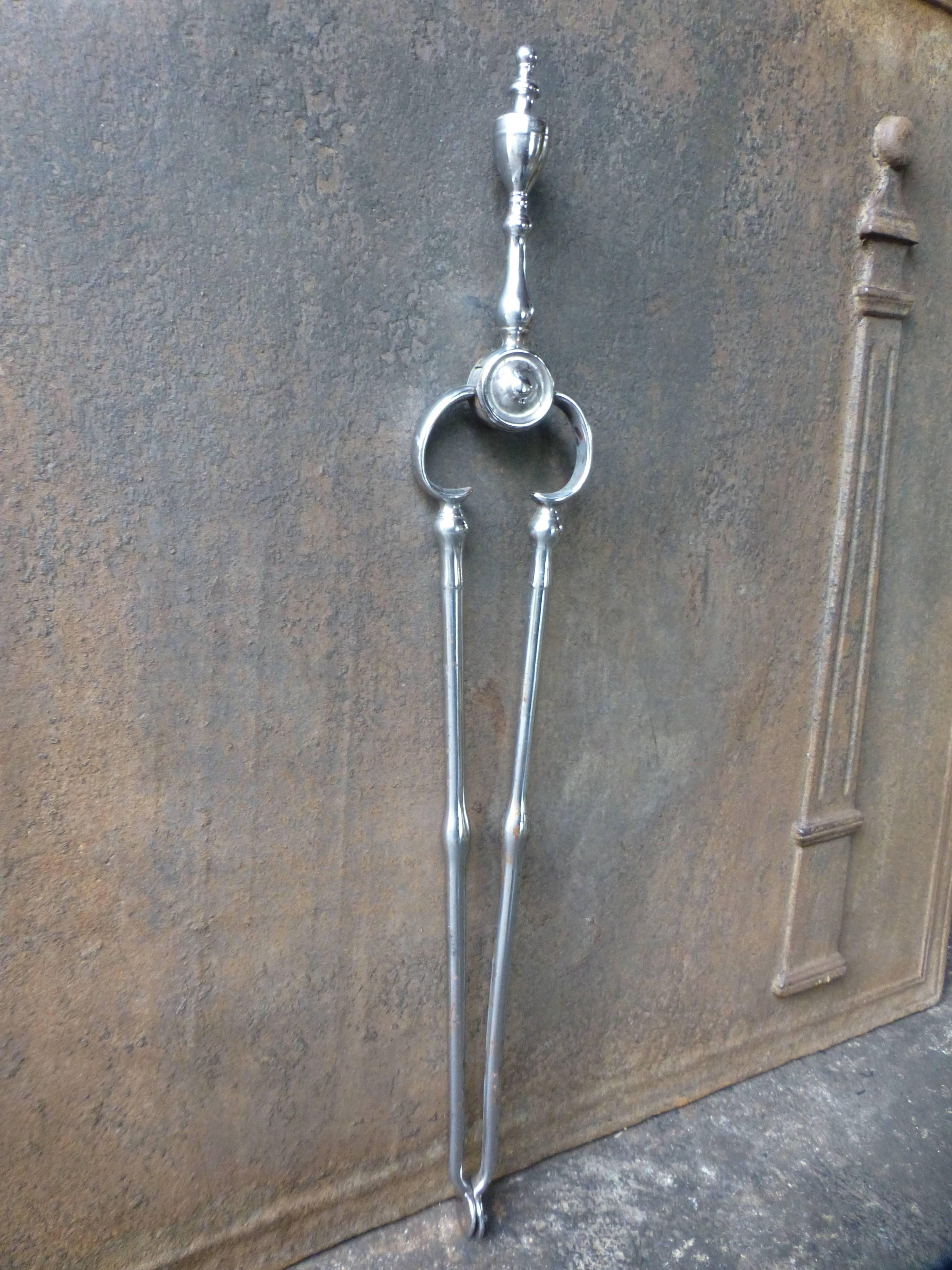 18th century English fireplace tongs or fire tongs made of polished steel.

We have a unique and specialized collection of antique and used fireplace accessories consisting of more than 1000 listings at 1stdibs. Amongst others we always have 300+